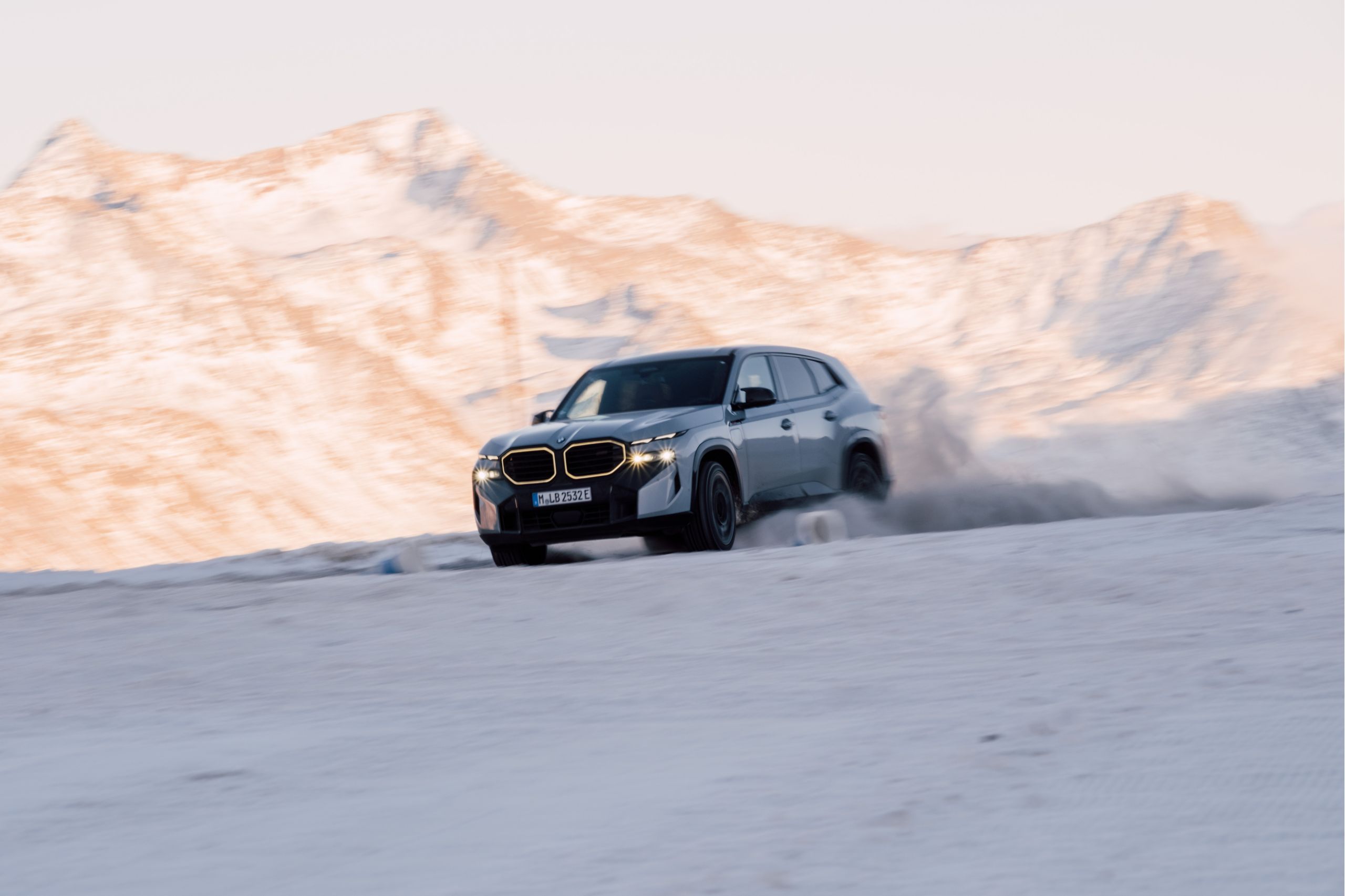 Grey sport car drifting on snowy terrain