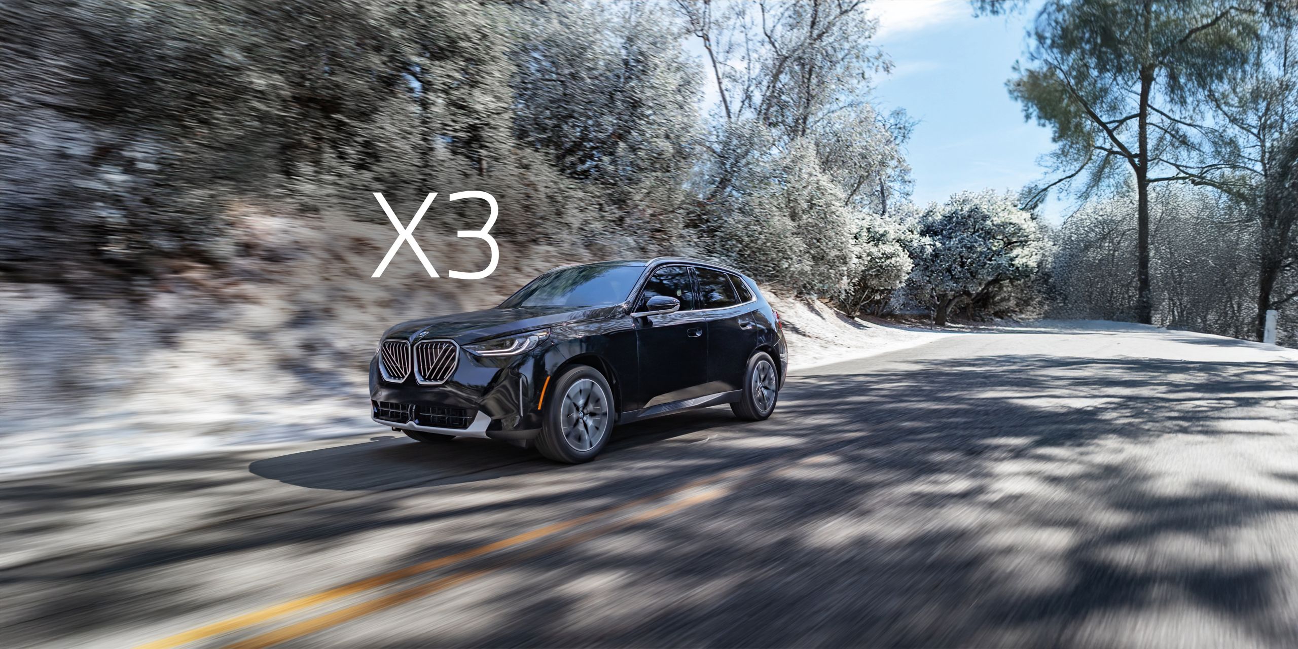 Dynamic shot of a 2026 BMW X3 30 xDrive cruising down a road