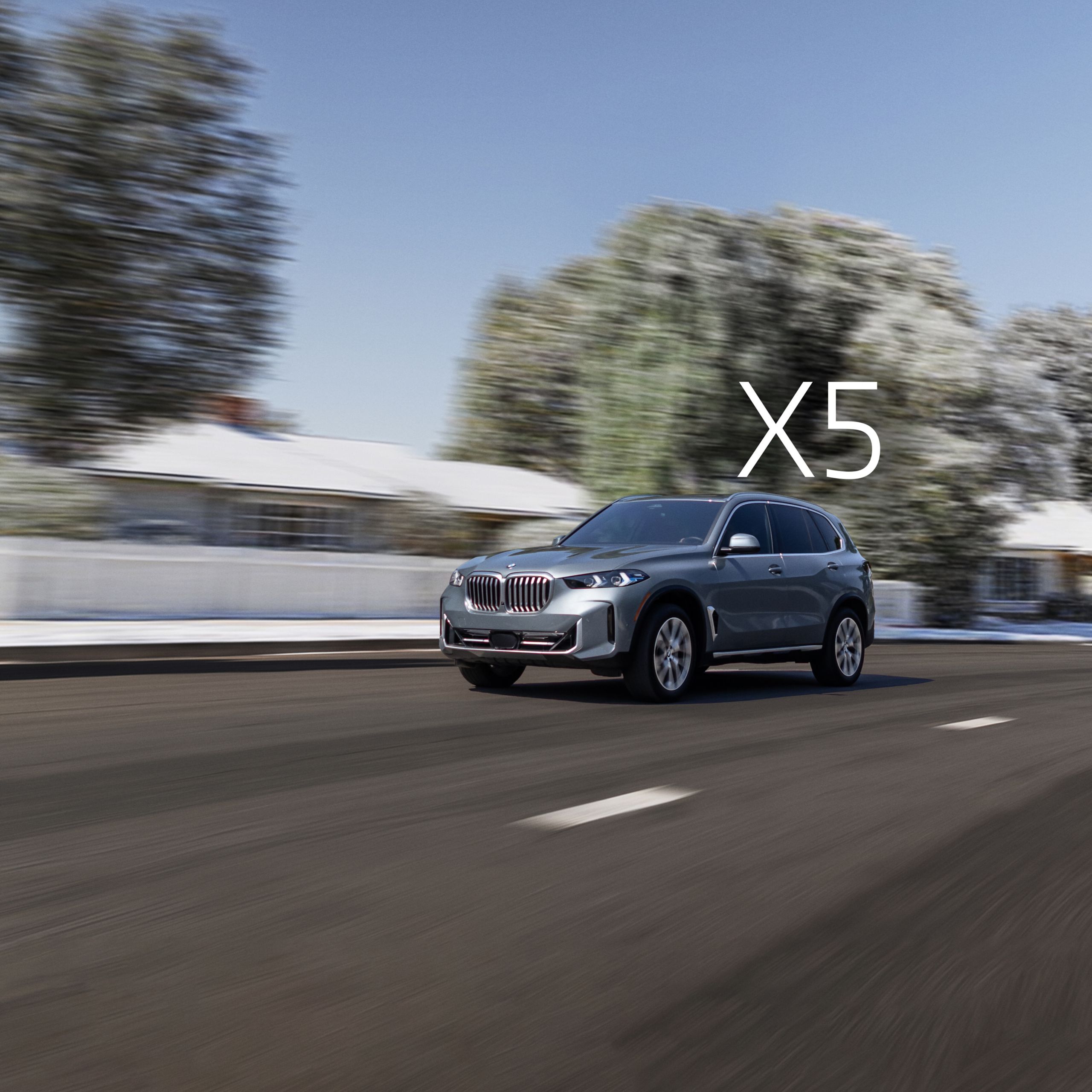 A 2026 BMW X5 xDrive40i passes a house as it drives down a road