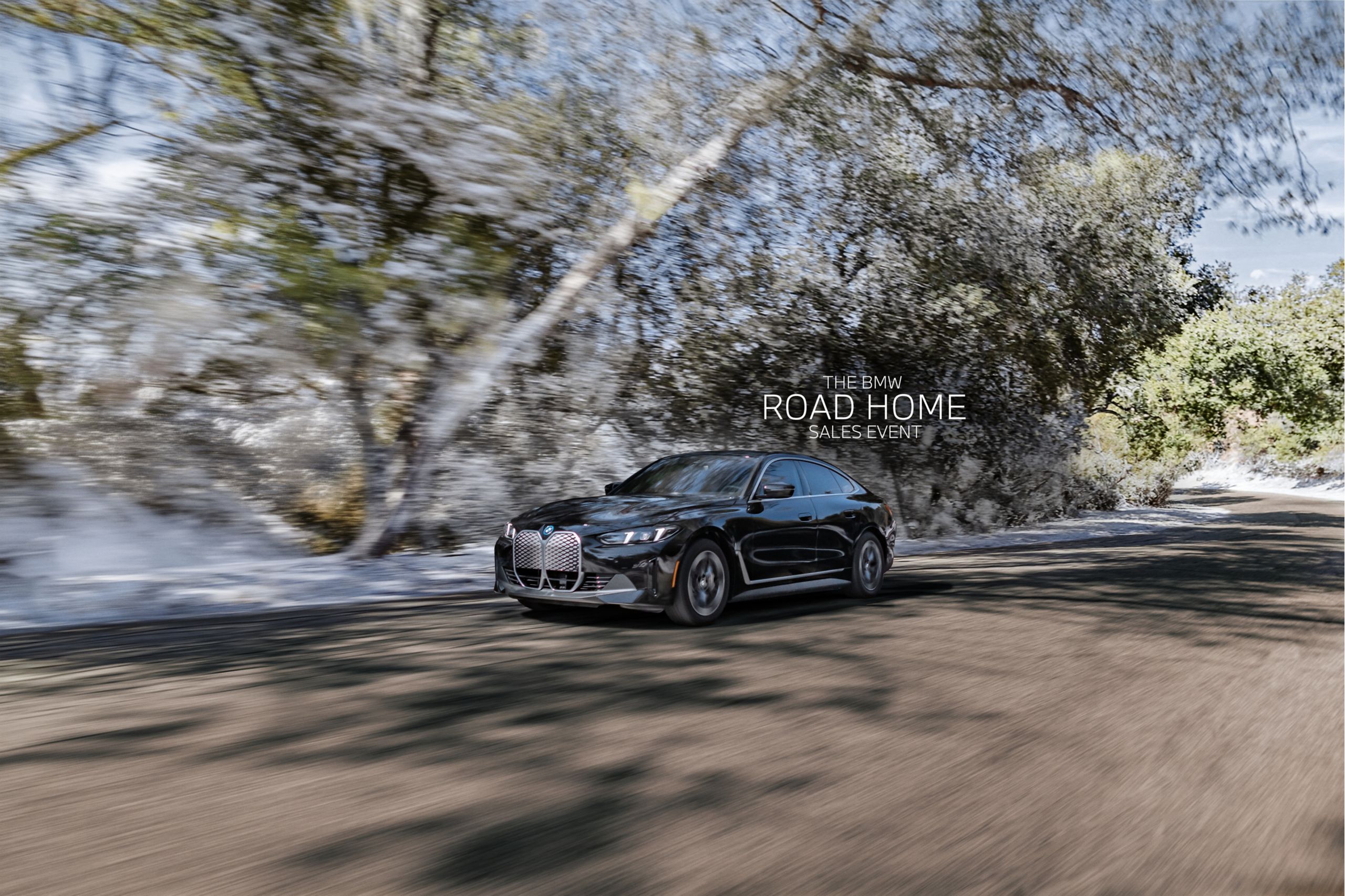Dynamic shot of a 2025 BMW i4 eDrive40 Gran Coupe on a forested road