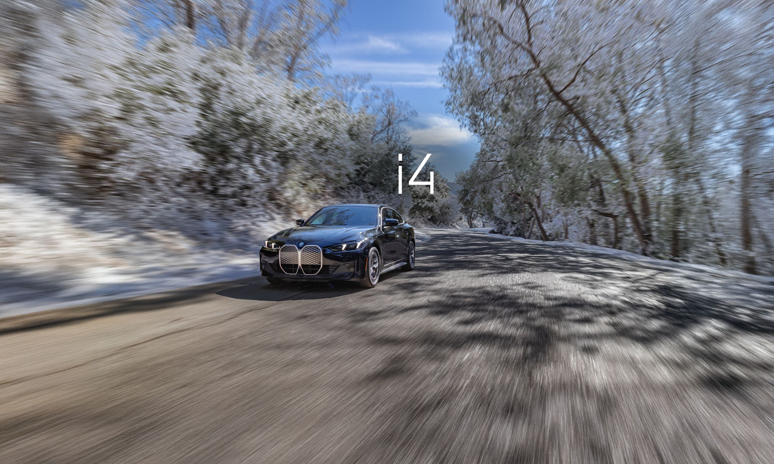 Dynamic shot of a 2025 BMW i4 eDrive40 Gran Coupe cruising down a road