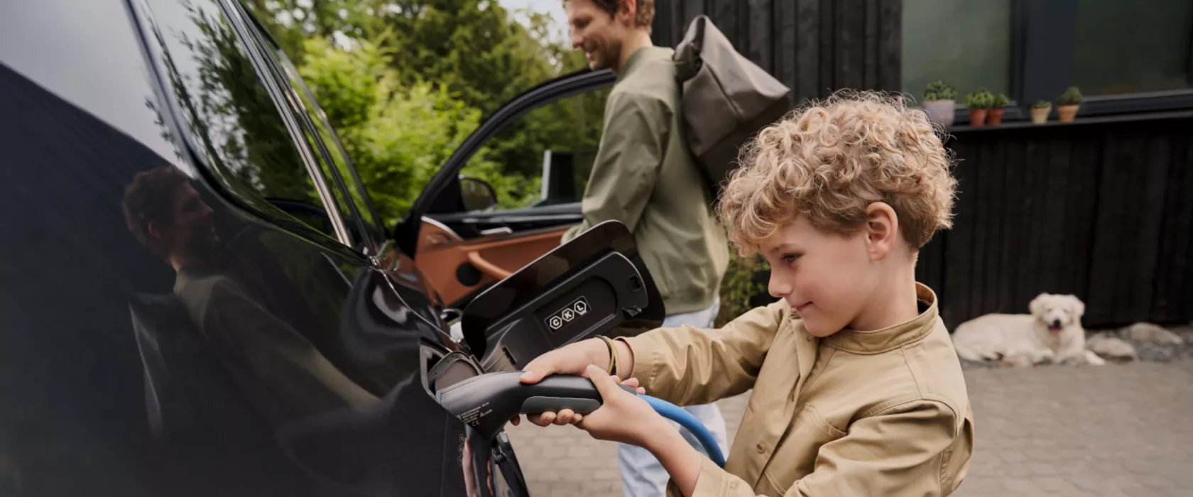 Woman smiling by BMW