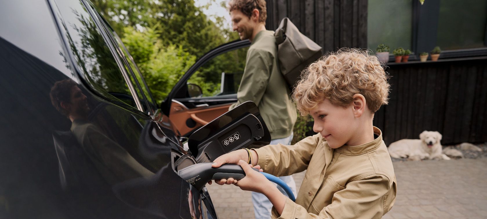 Woman smiling by BMW