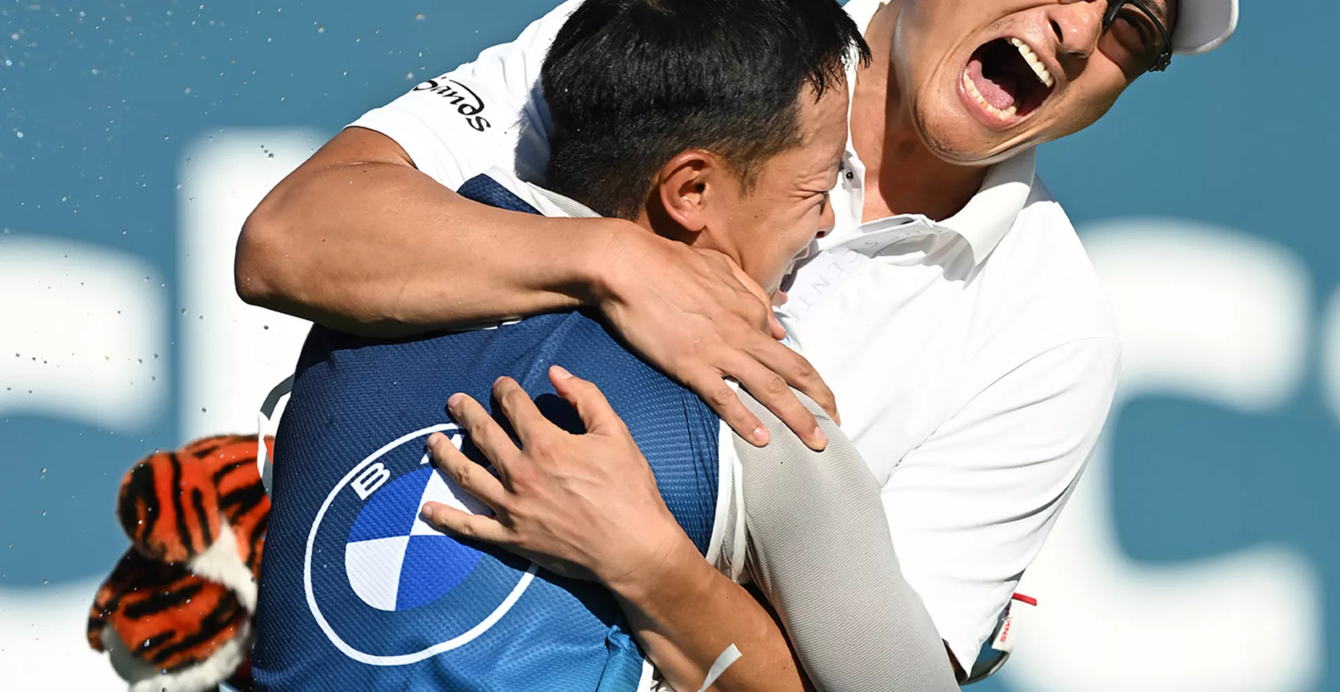 Haotong Li celebrates with his caddie