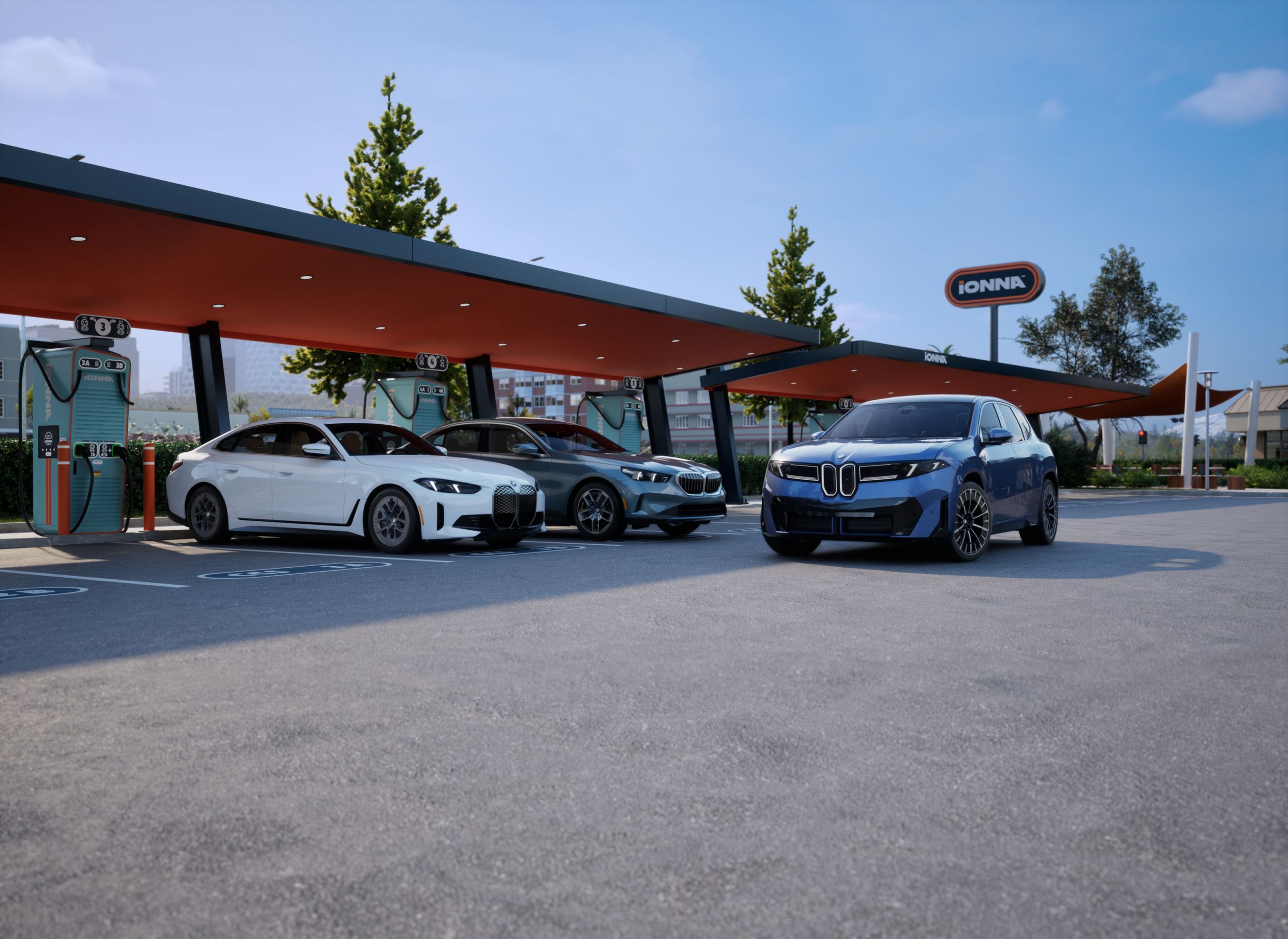A BMW i4, i5, and iX parked at an IONNA charging station