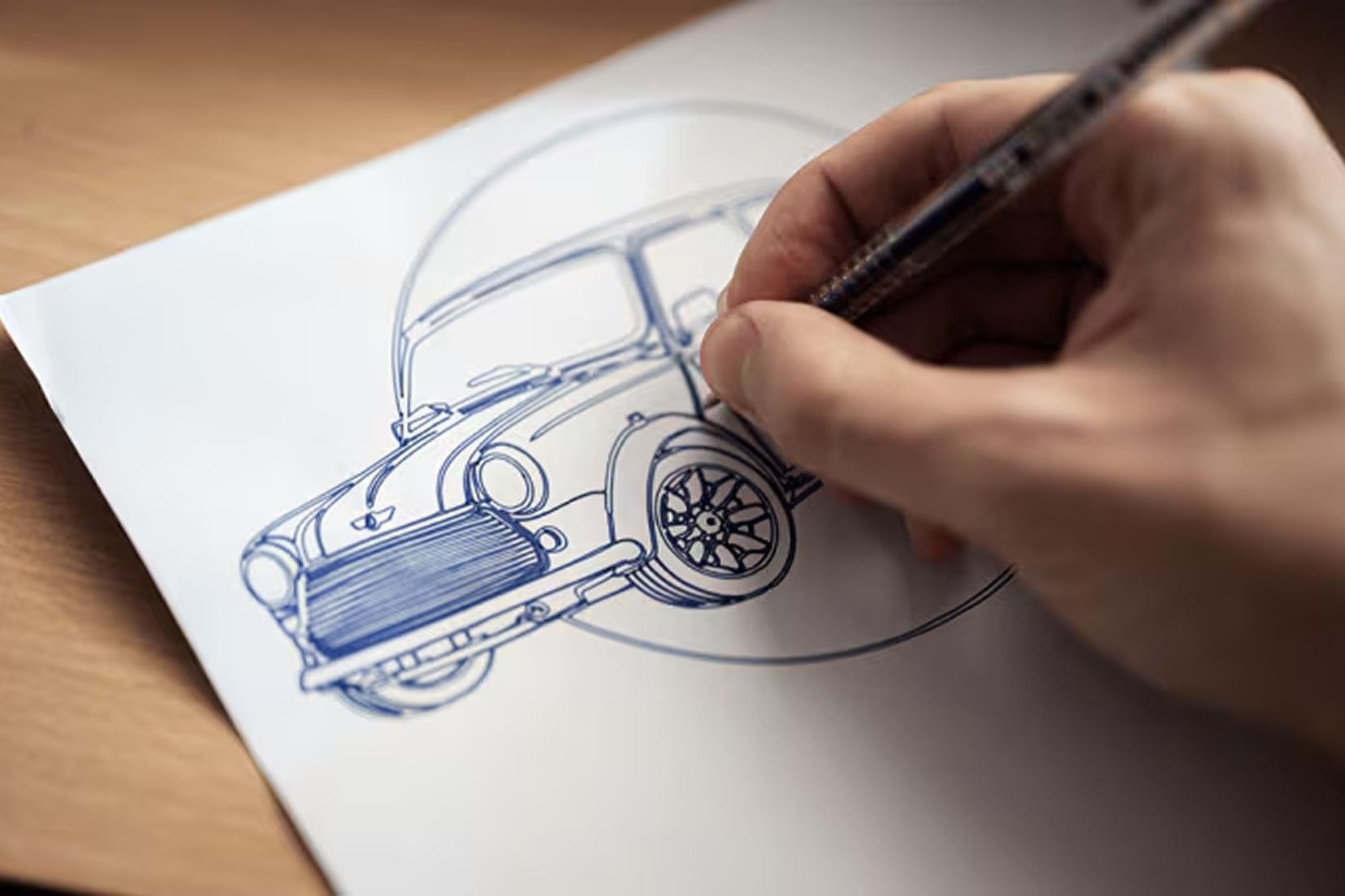 A close up of someone drawing a MINI vehicle