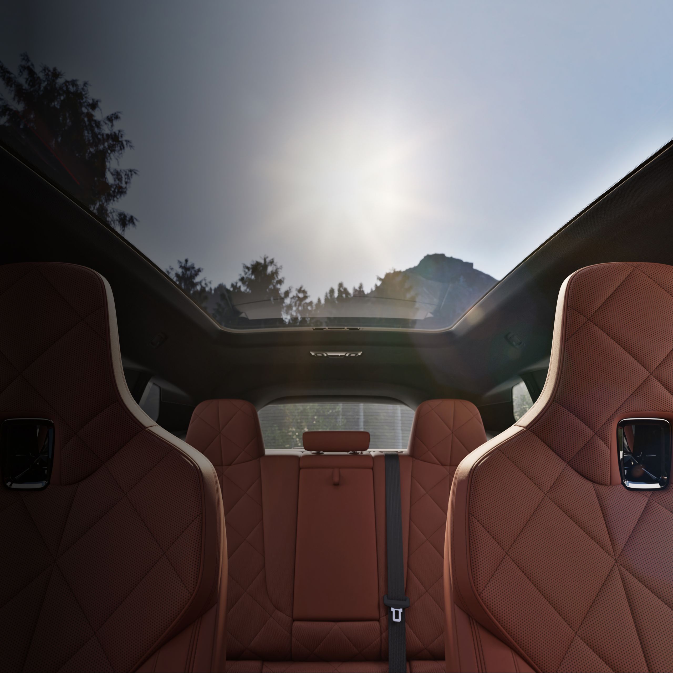 A interior shot of the BMW iX with the sun shining through the Panoramic Eclipsing Roof