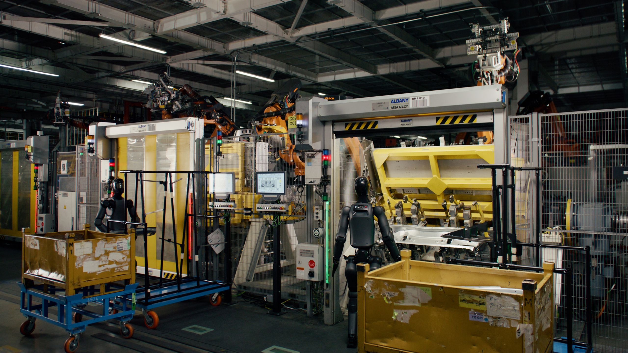 A shot from behind of a BMW as its being assembled by robots inside a factory.