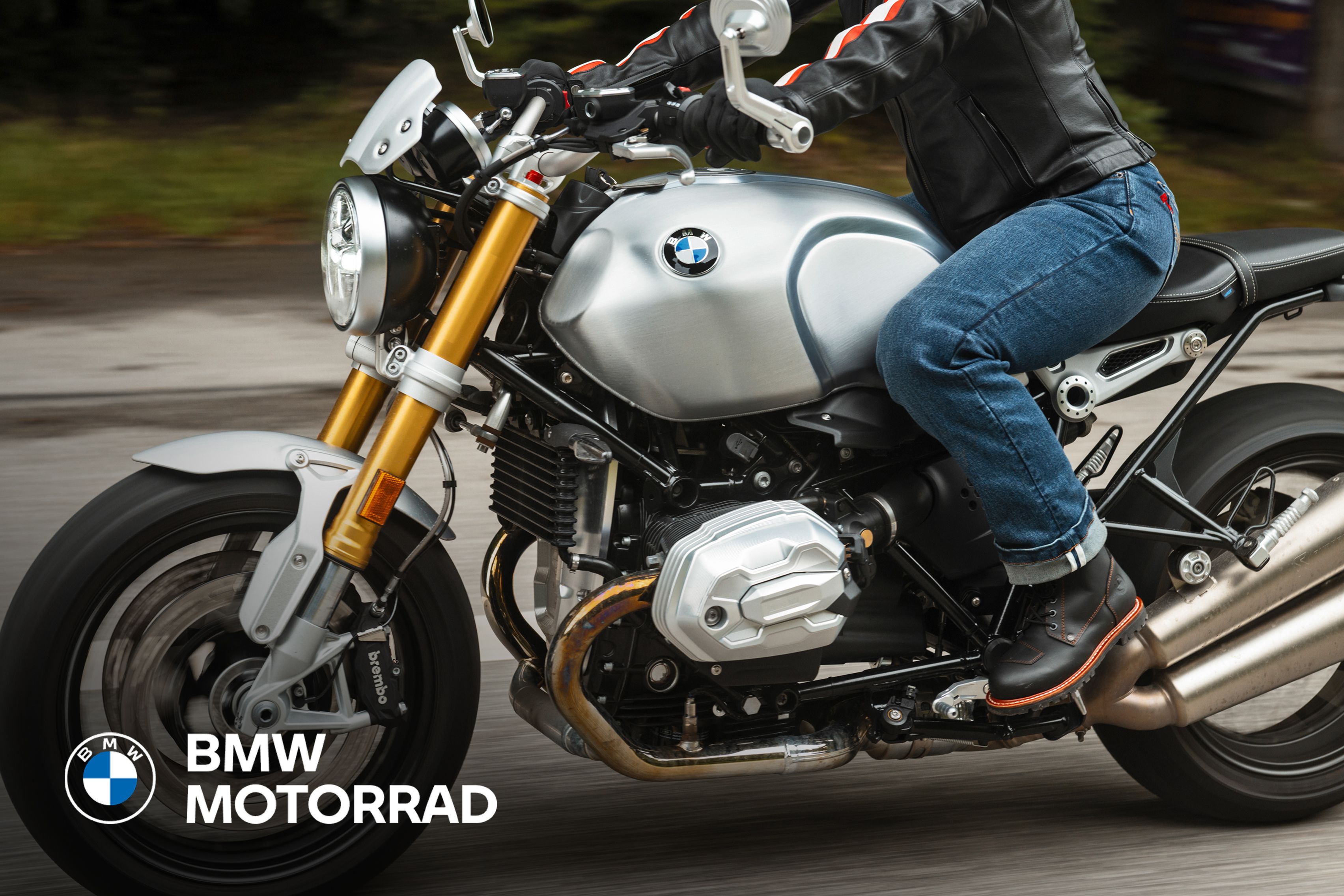 Side shot of a person driving a BMW motorcycle