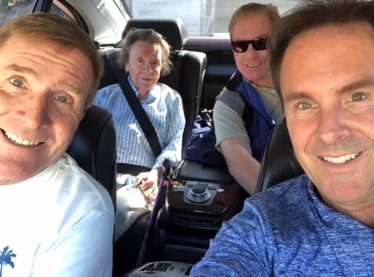 A selfie photo of Bill Curry, his brothers, and his mother inside his car