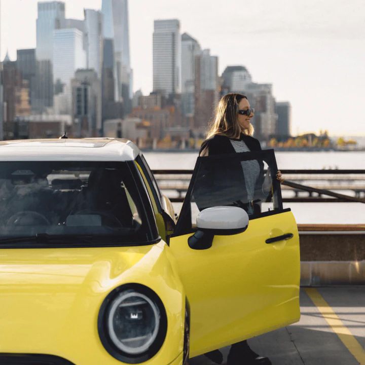 A woman stepping out of a MINI