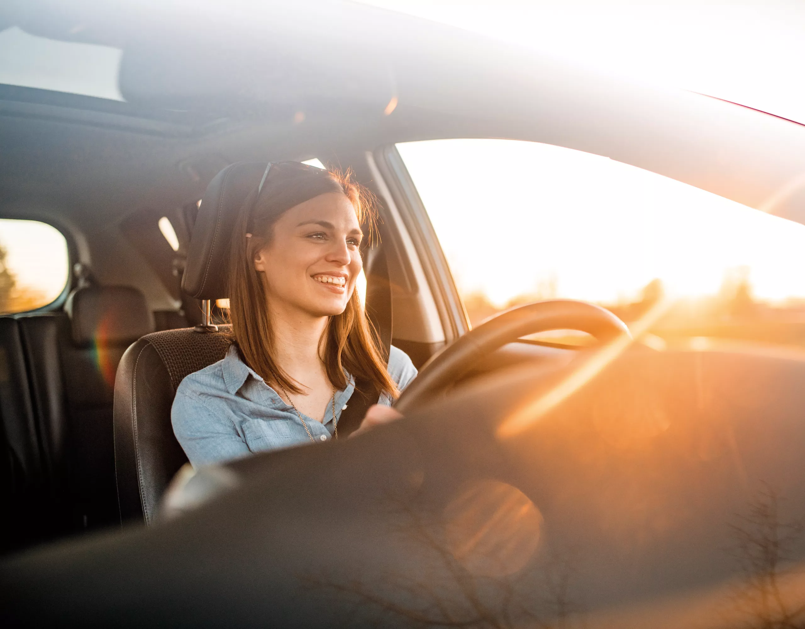 BMW three-quarter front view in front of mountain landscape with woman and man