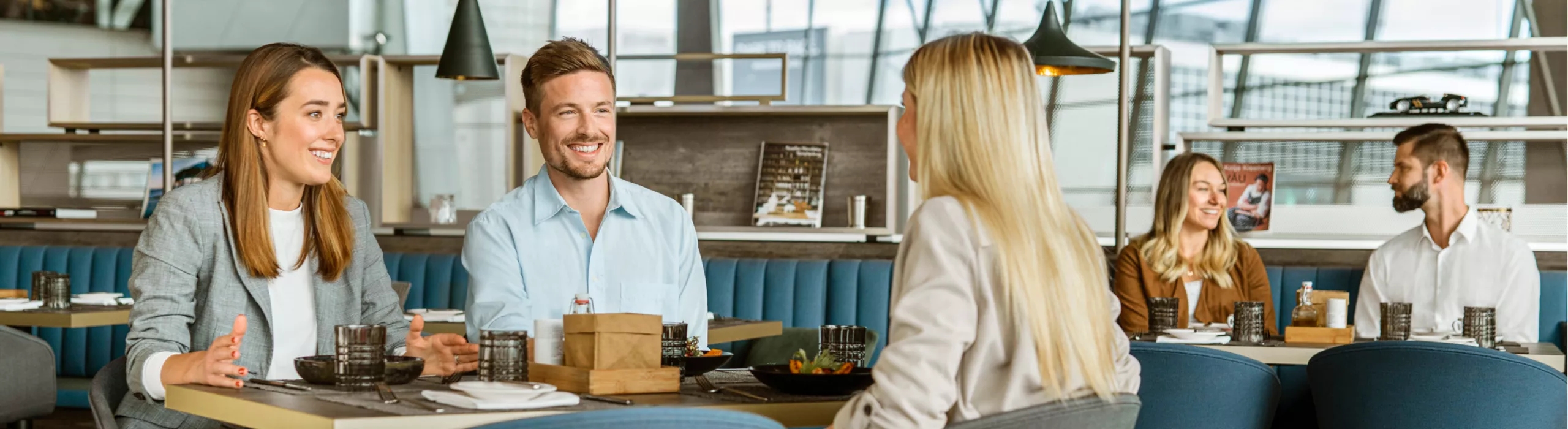 laughing people enjoy dining together