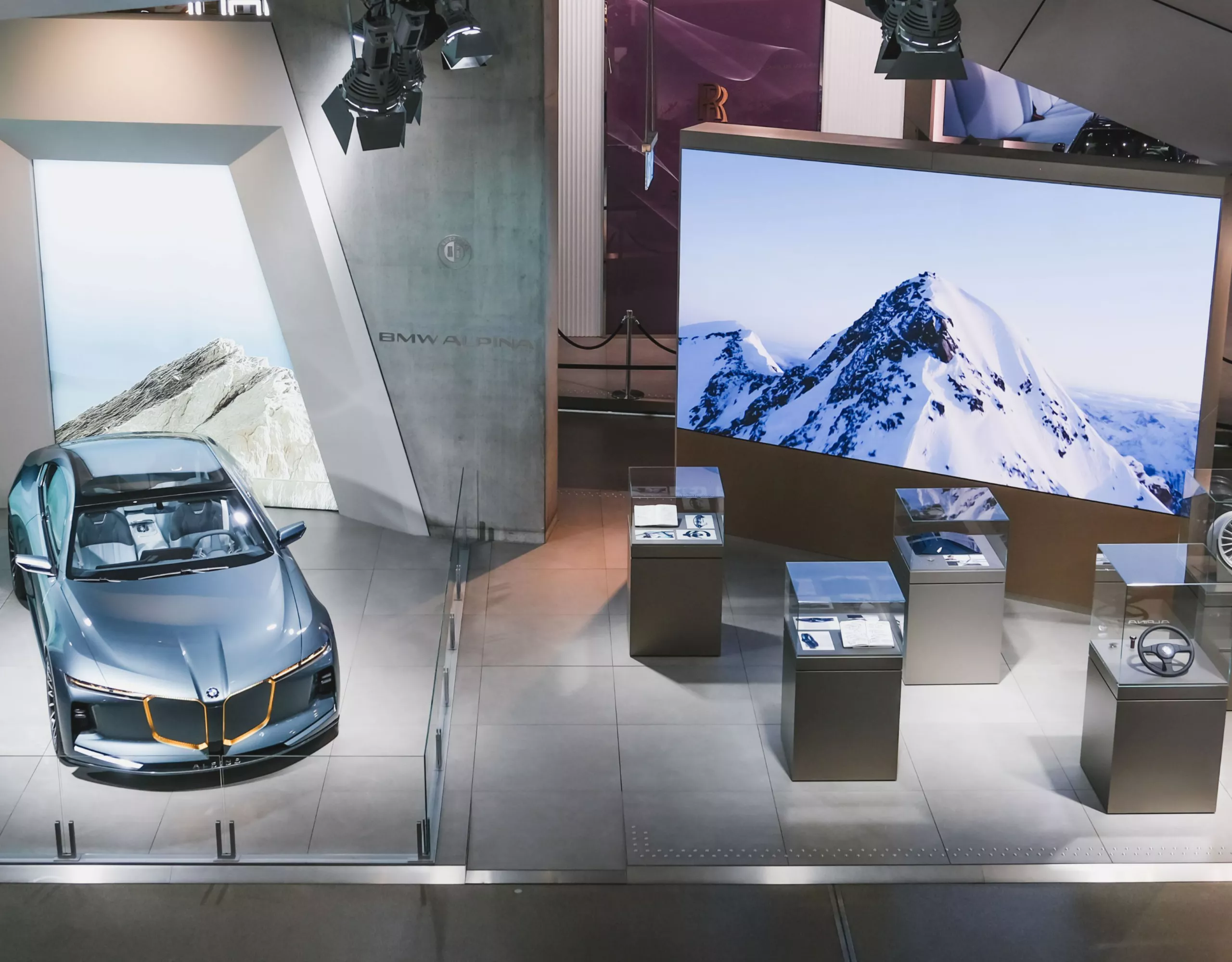 BMW ALPINA Concept vehicle displayed at BMW Welt in Munich in a modern exhibition space with large-scale screens and display elements.