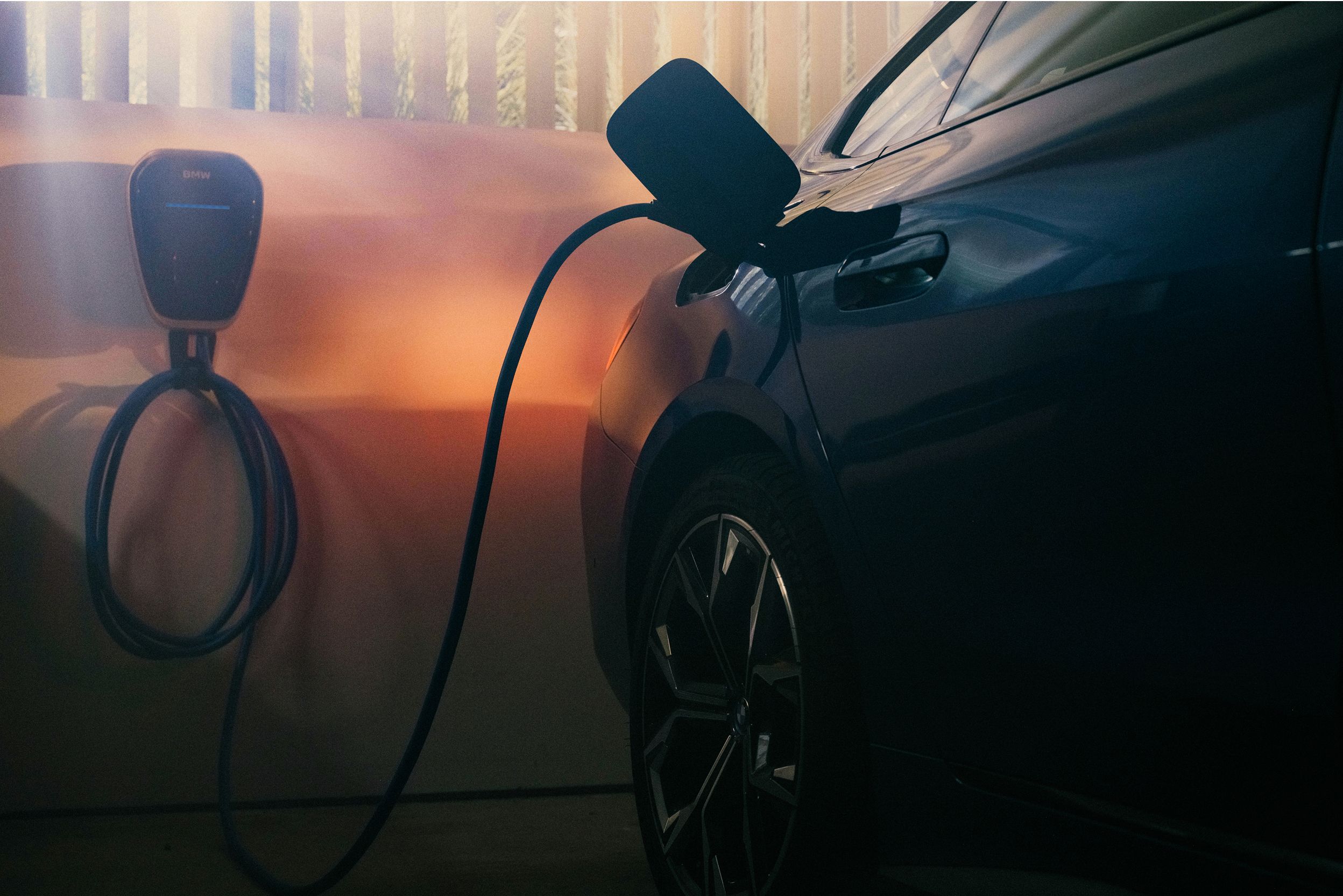A BMW plugged into a BMW Wallbox