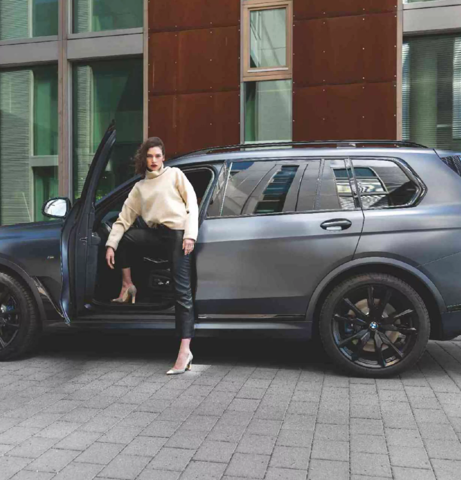 BMW Financial Services couple in front of BMW in a building
