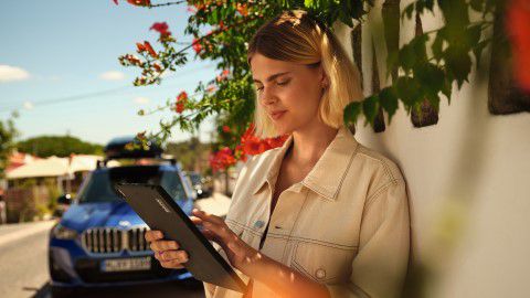 BMW Financial Services man leaning against BMW