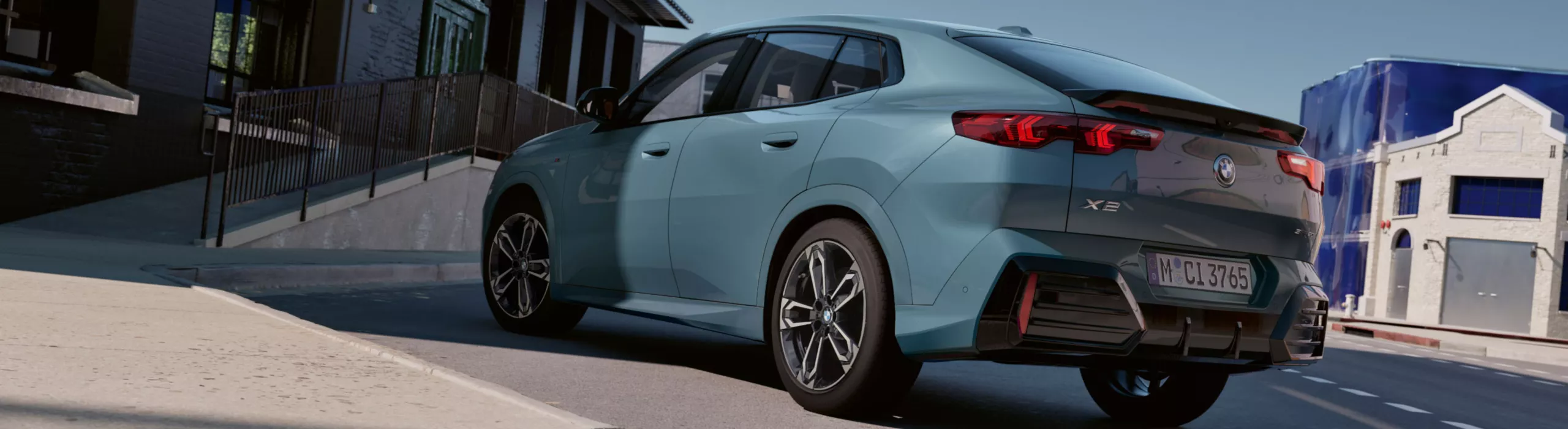 Exterior View of the BMW X2 sDrive20i in Capeyork Green in an urban environment in front of an office