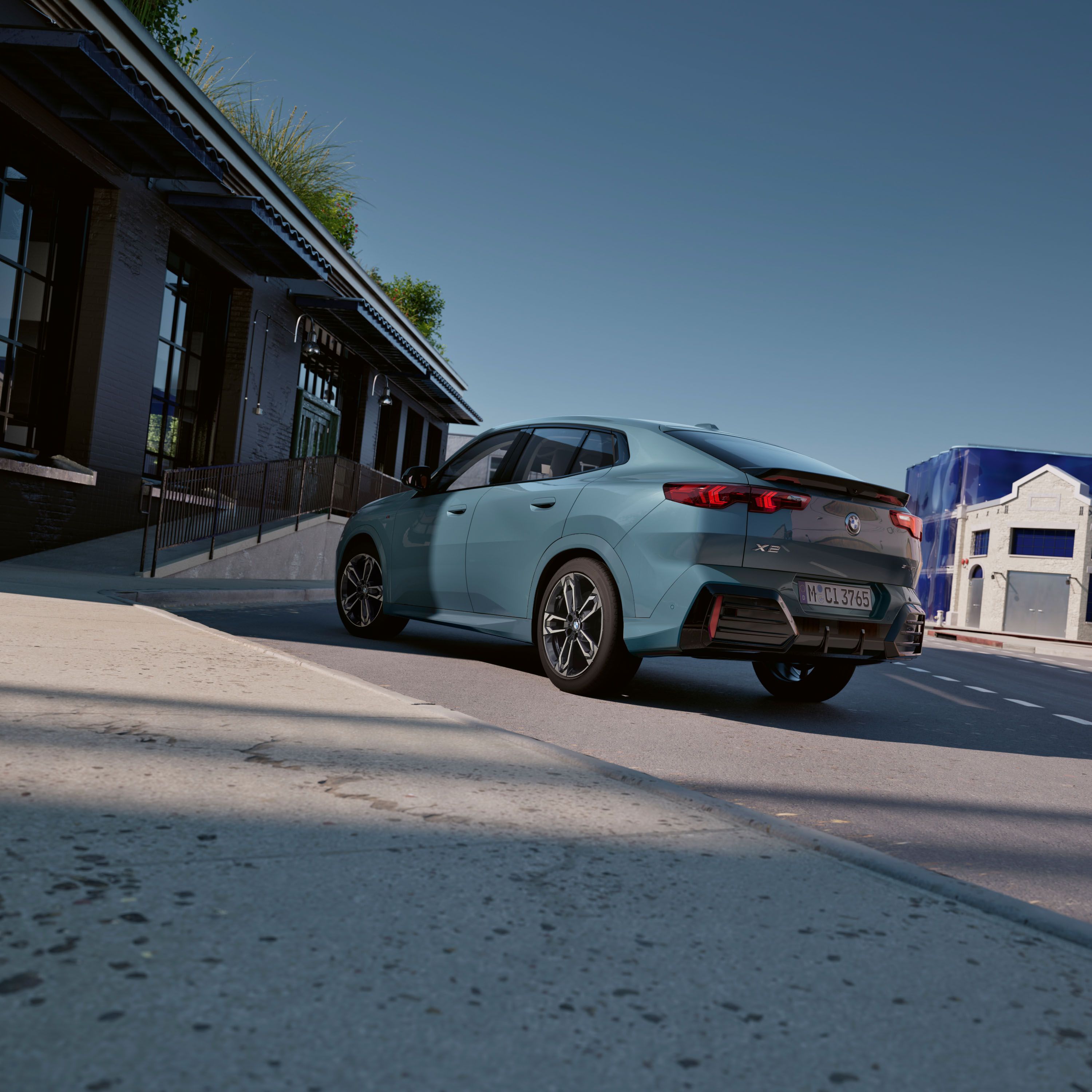 Exterior View of the BMW X2 sDrive20i in Capeyork Green in an urban environment in front of an office