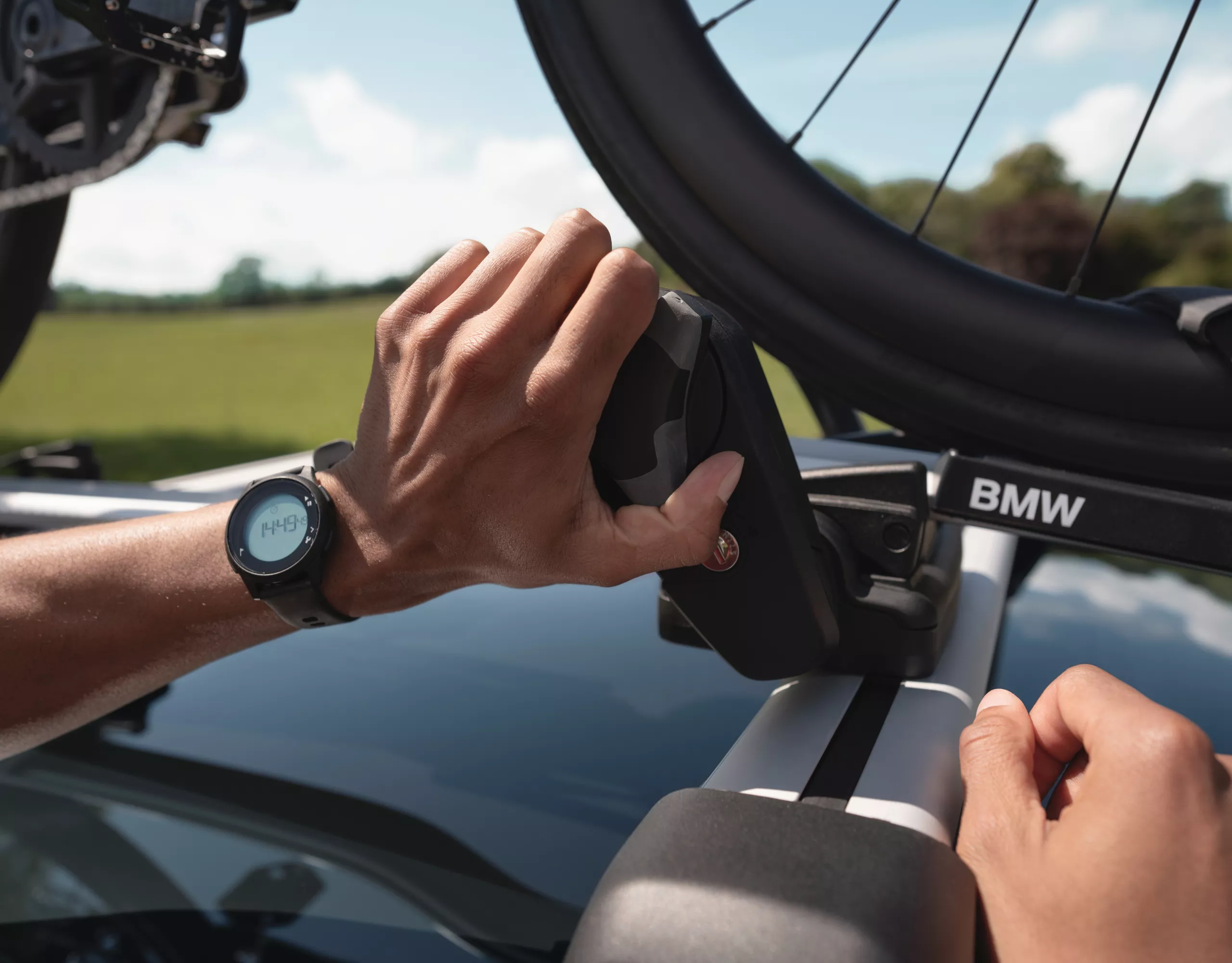 BMW with two bicycles mounted on the rear bike rack is parked on the street