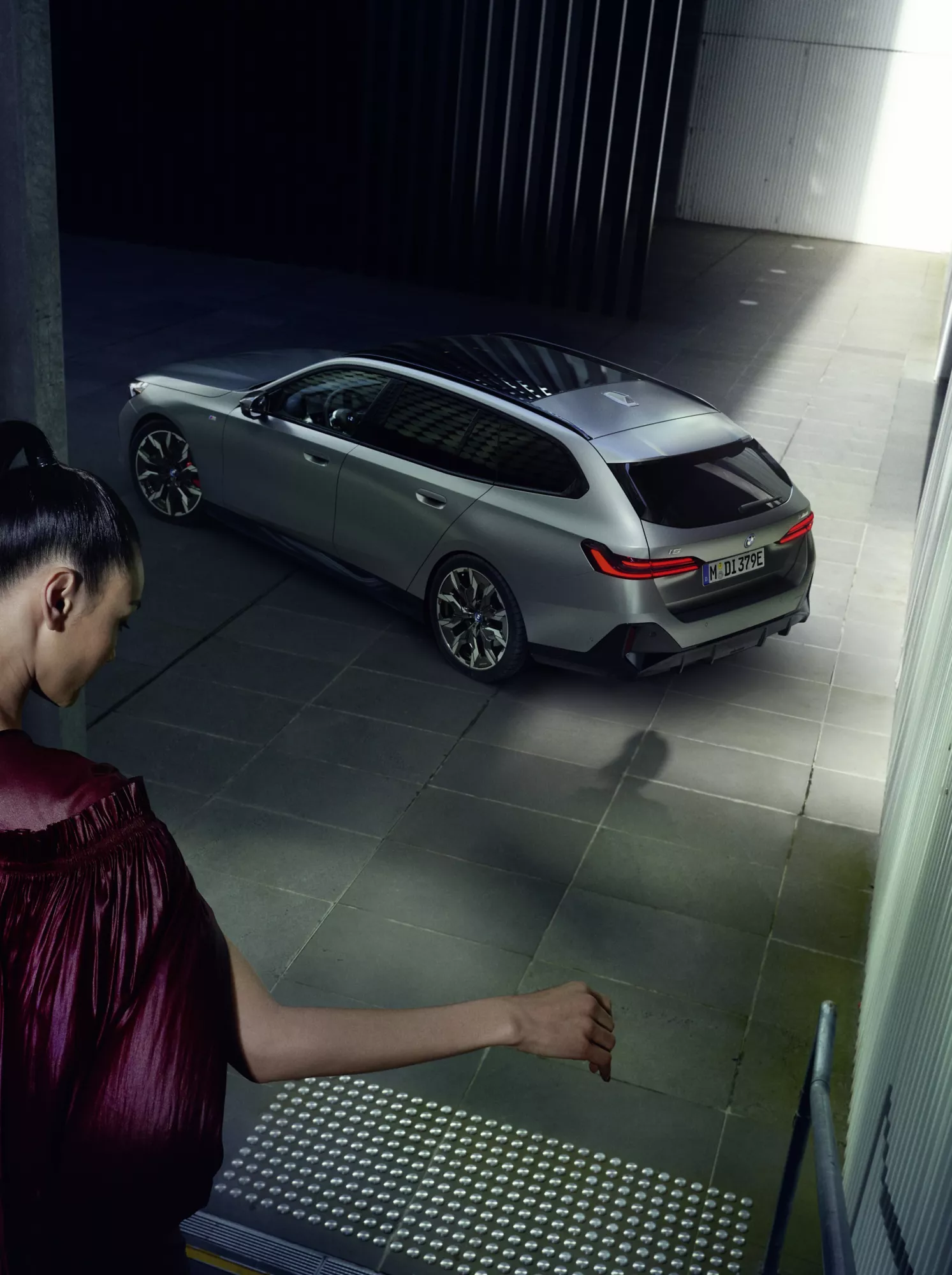 Girl going down the stairs to a parked BMW Touring