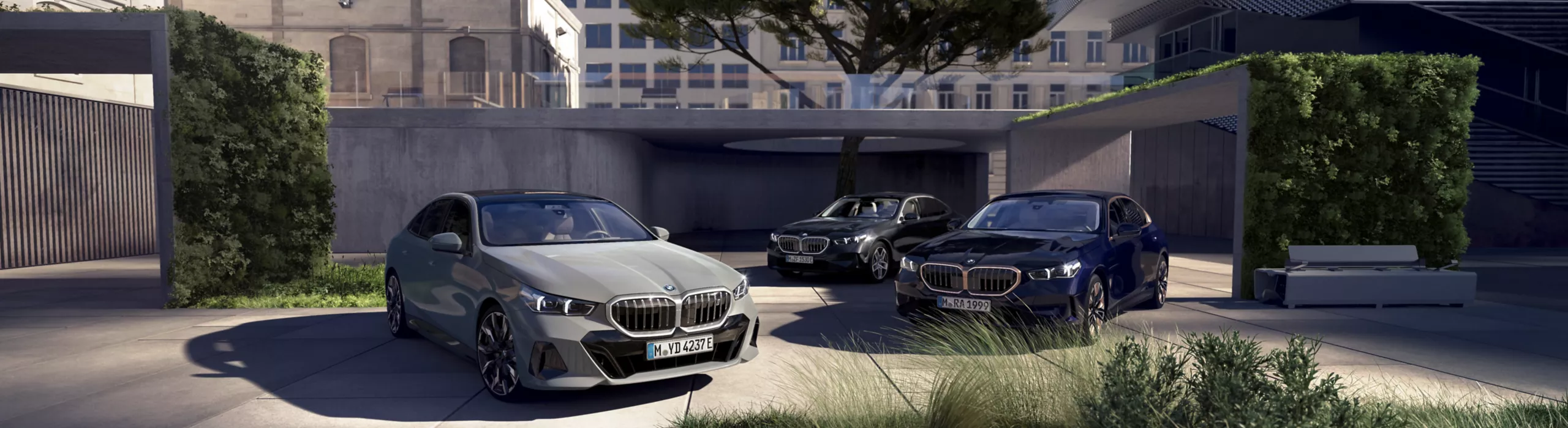 BMW SUV parked on a residential street with contemporary houses and trees nearby.