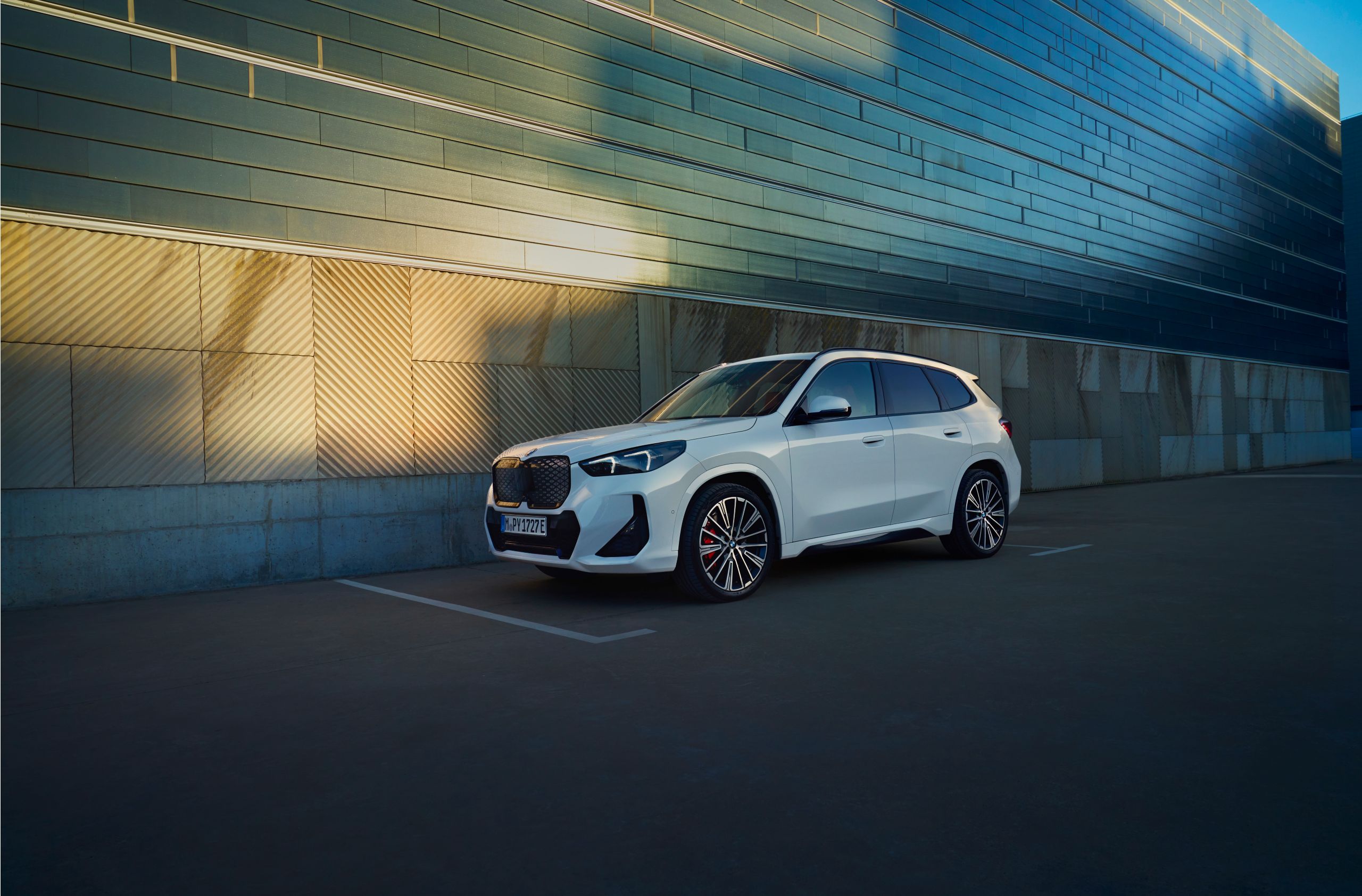 White SUV parked near modern building