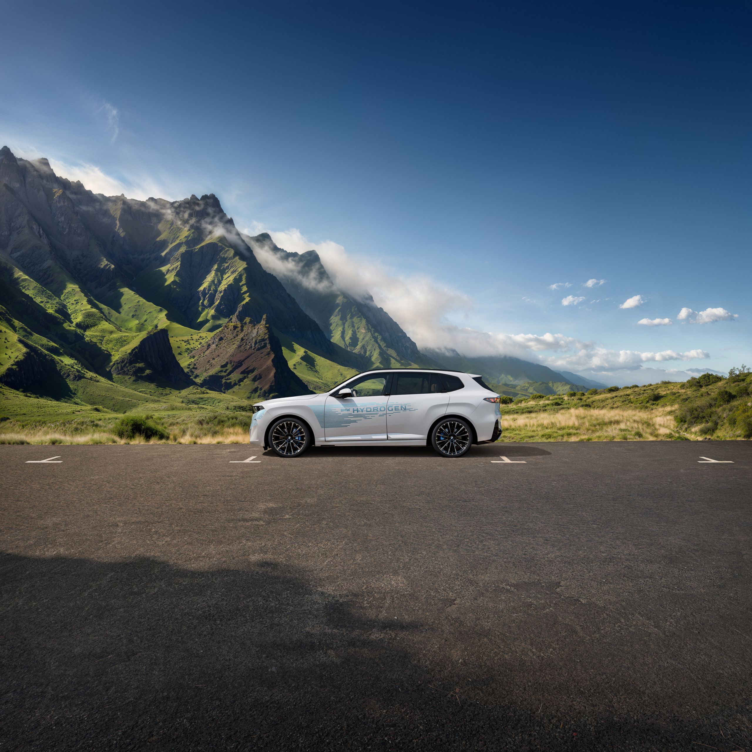 A concept hydrogen-run BMW parked in front of a mountain background