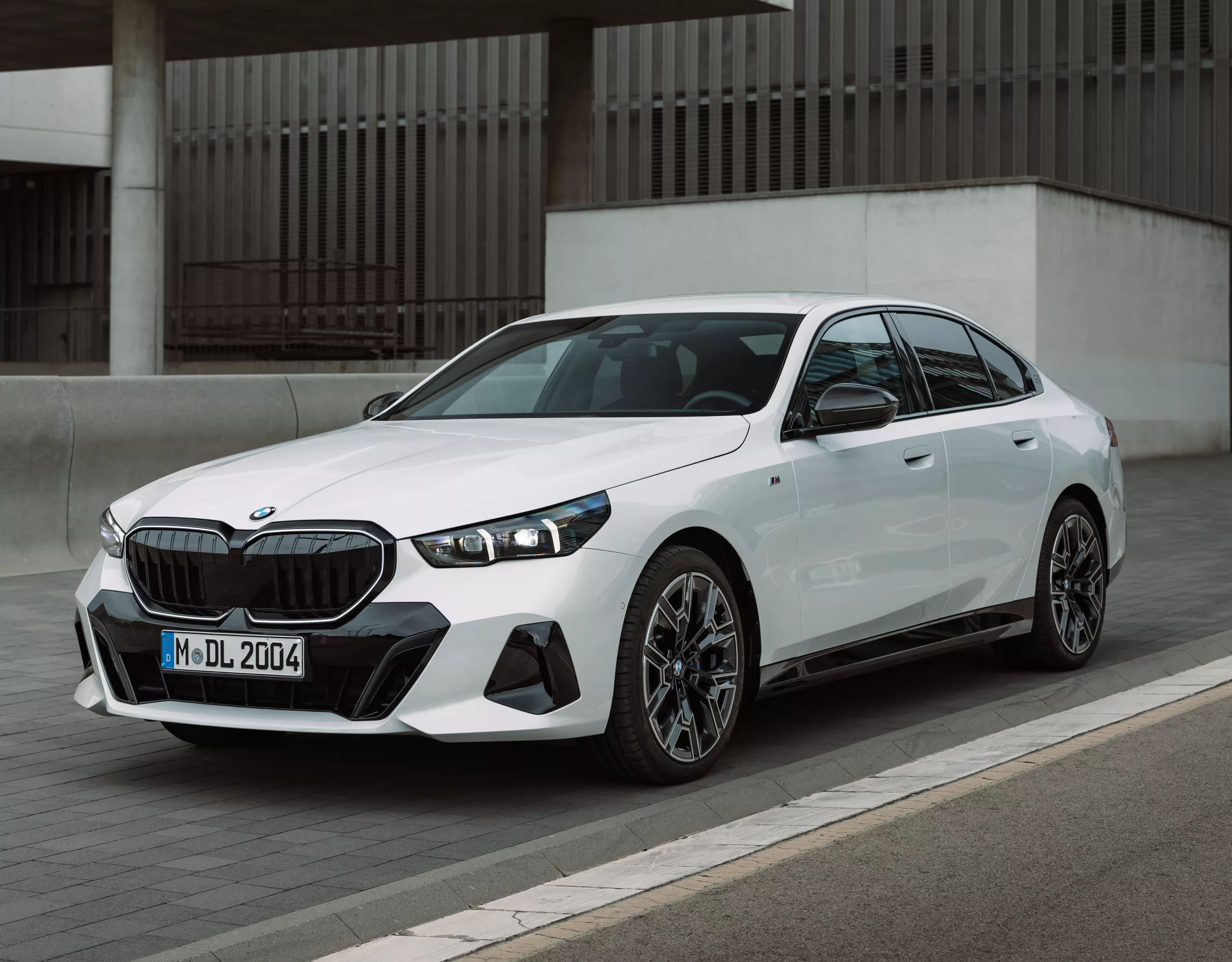 A BMW drives along a road