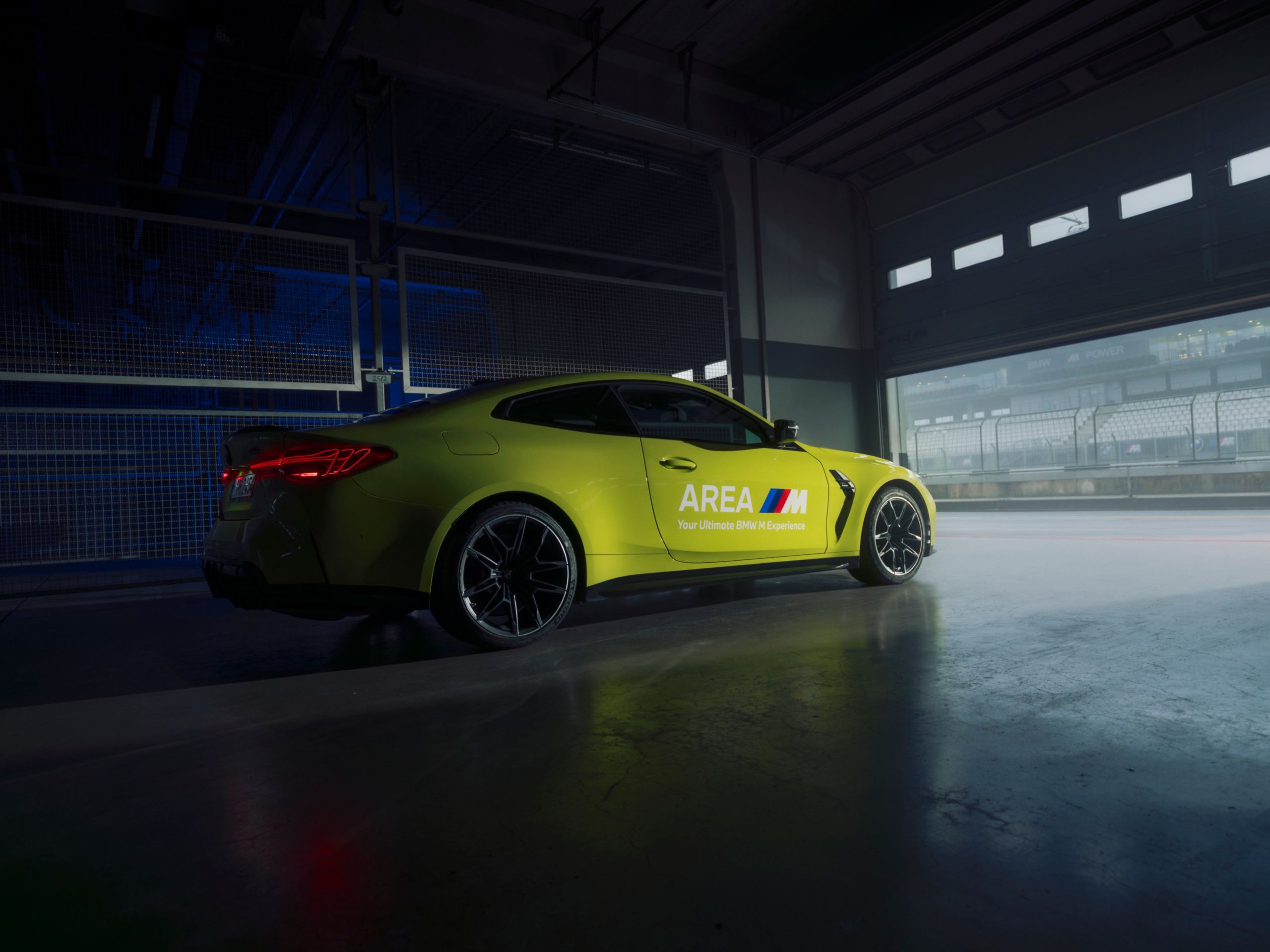BMW M4 in Sao Paulo Yellow on pit lane.