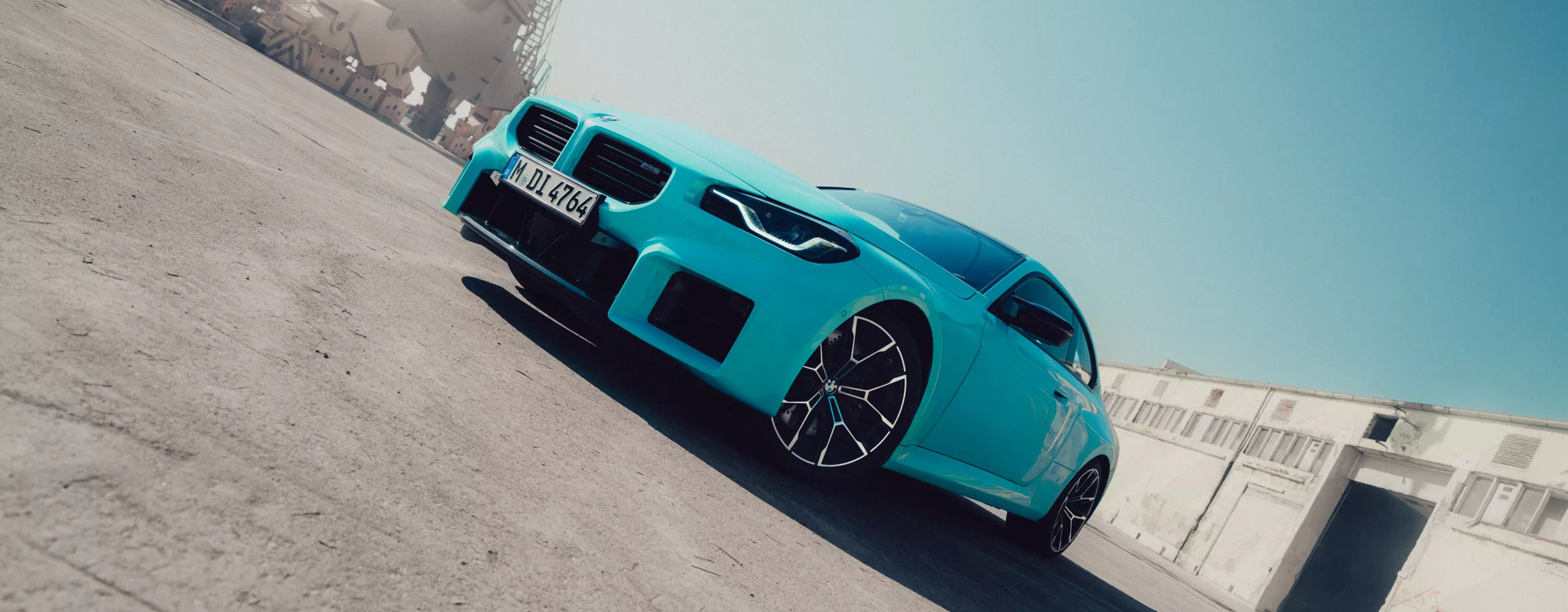 A dynamic driving video showcases the vehicle from all angles as it navigates winding roads through a scenic landscape, driven by a male model.