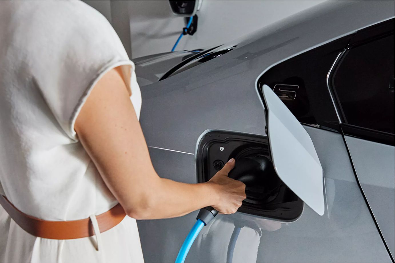 A woman charging her BMW using the BMW Wallbox.