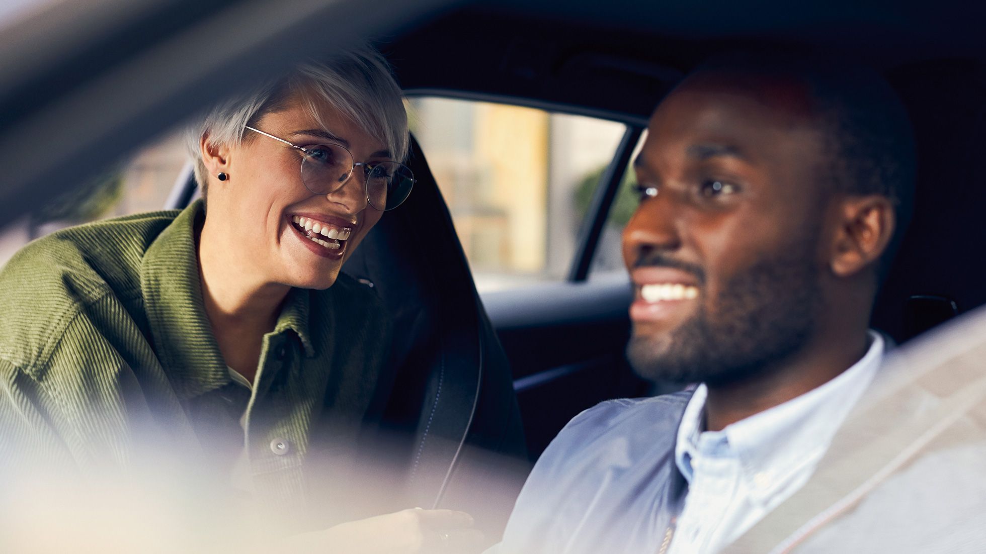Two people in a car interior setting