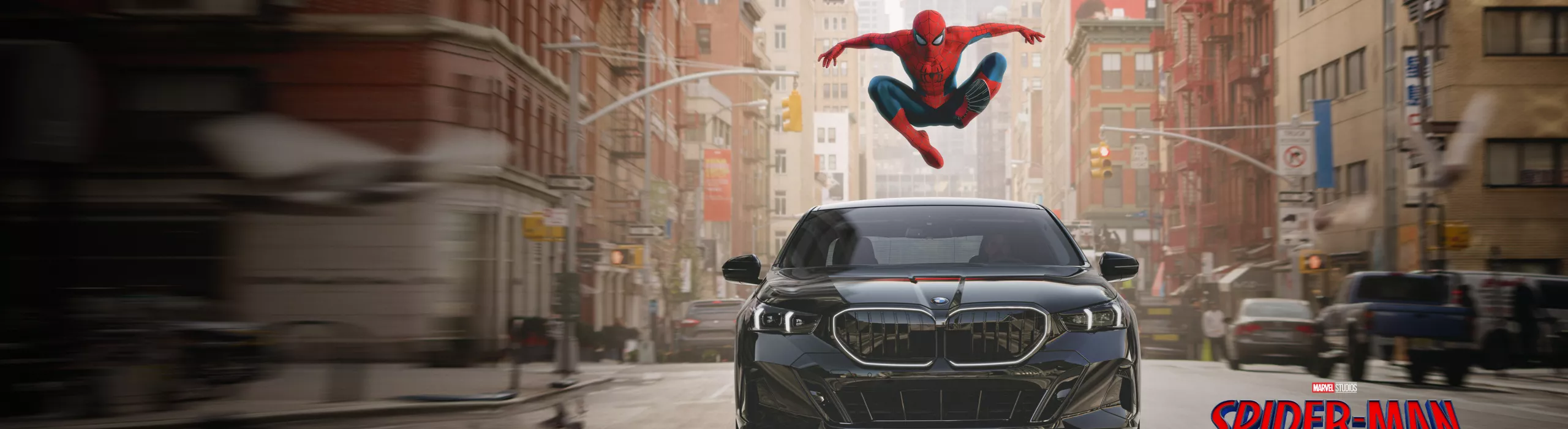 Spider-Man leads over a BMW 5 Series in the middle of a city street. The logo for the film Spider-Man: Brand New Day sits in the bottom right corner.