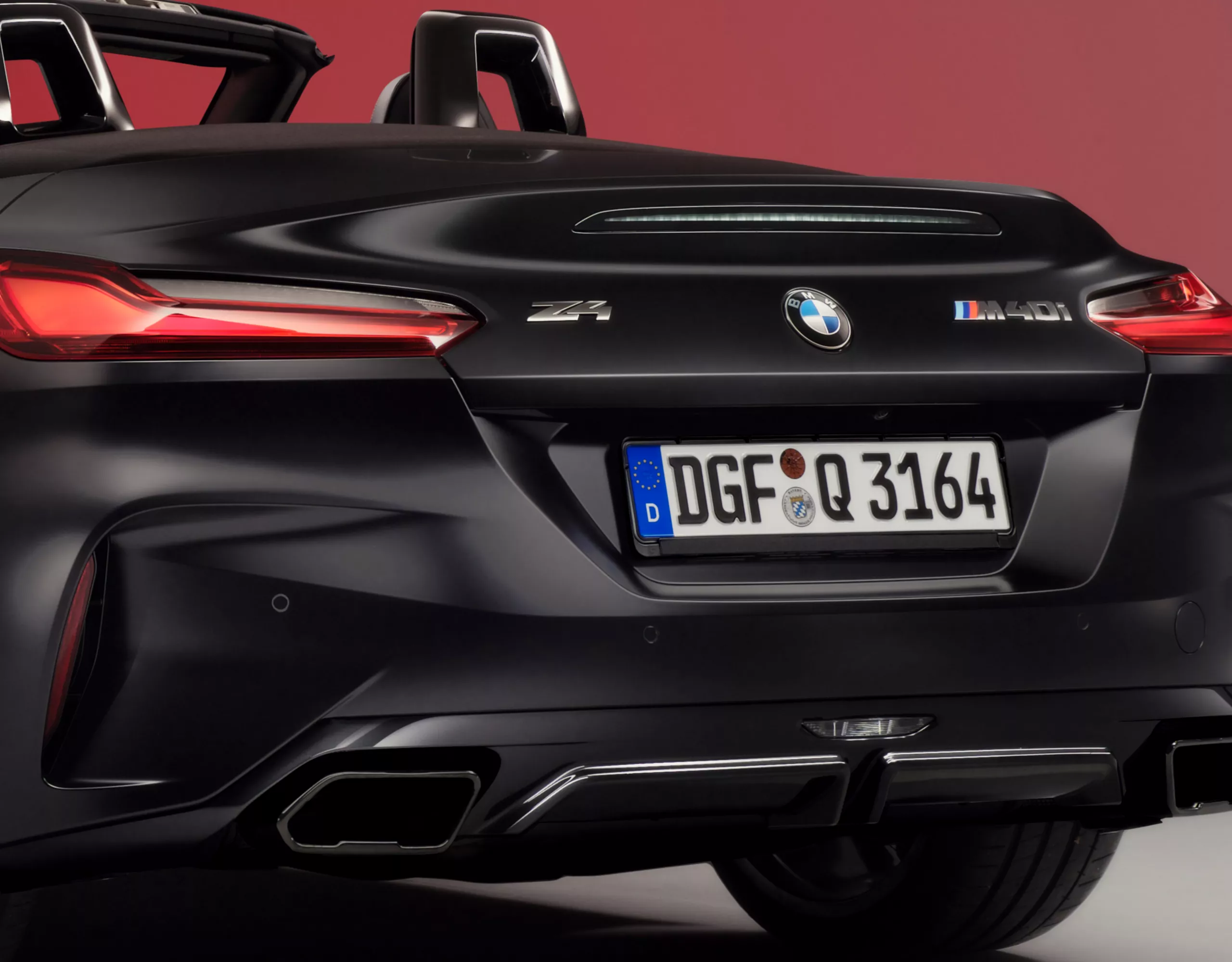 A striking rear view of the BMW Z4 Roadster, highlighting its sculpted proportions, slim LED taillights, and athletic stance