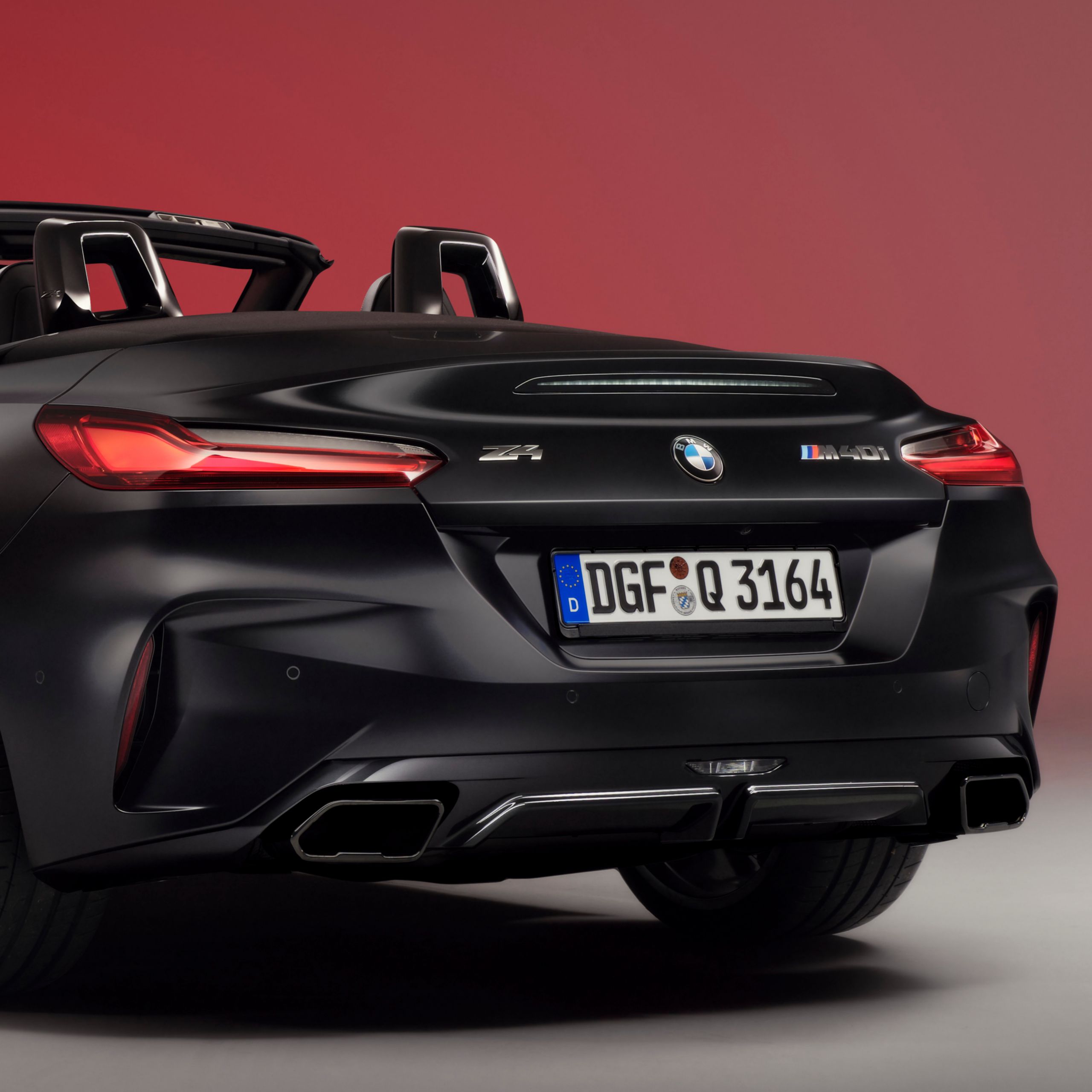 A striking rear view of the BMW Z4 Roadster, highlighting its sculpted proportions, slim LED taillights, and athletic stance