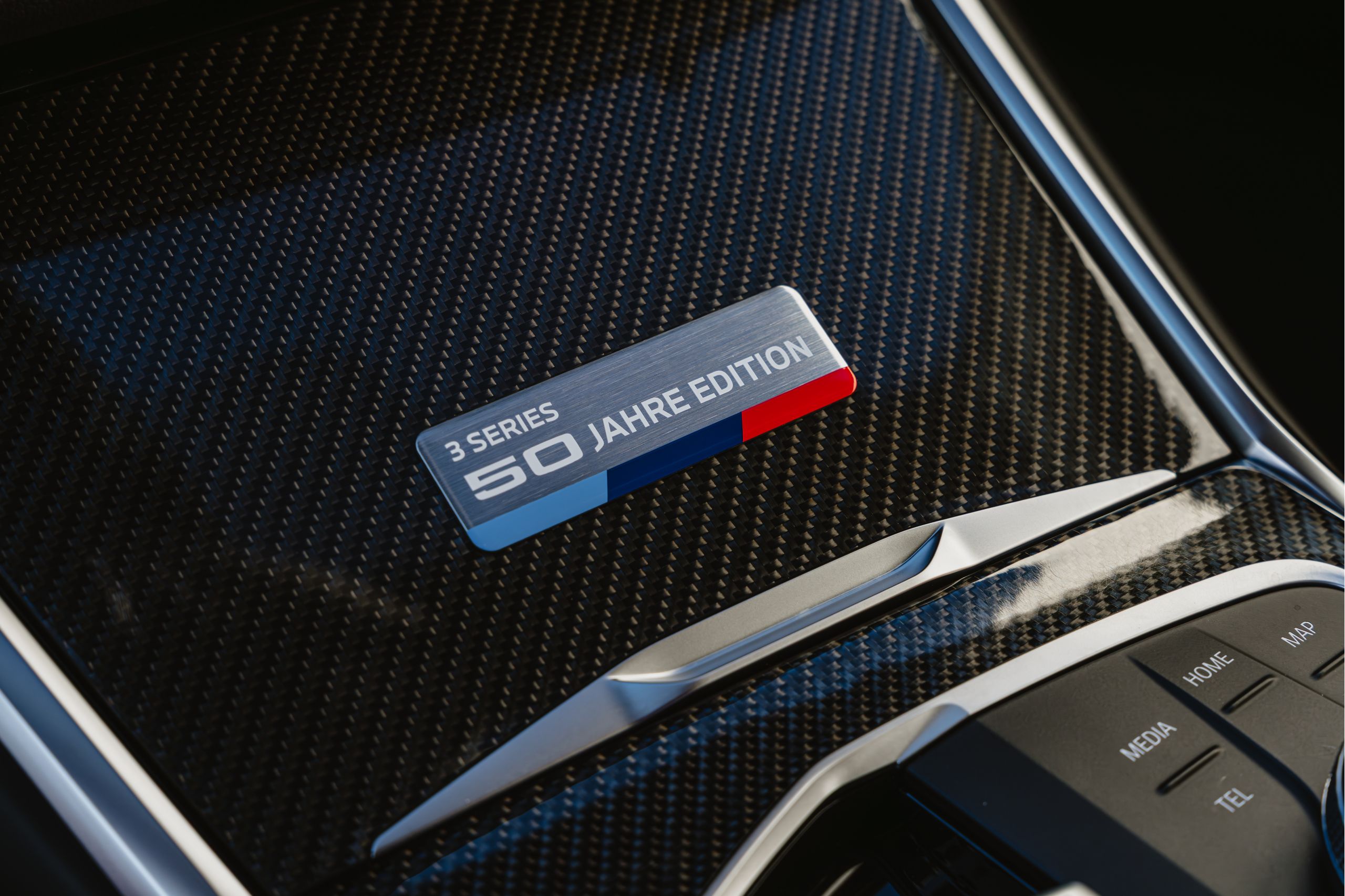 Detail of the limited edition badging on the cup holder of a BMW M340i xDrive 50 Jahre Edition