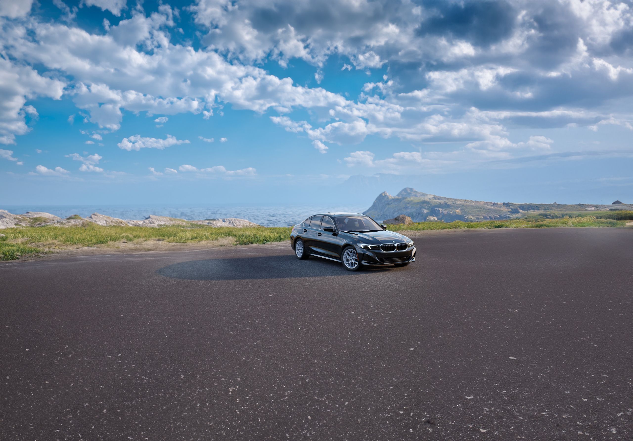 A BMW 3 Series parked near a seaside cliff