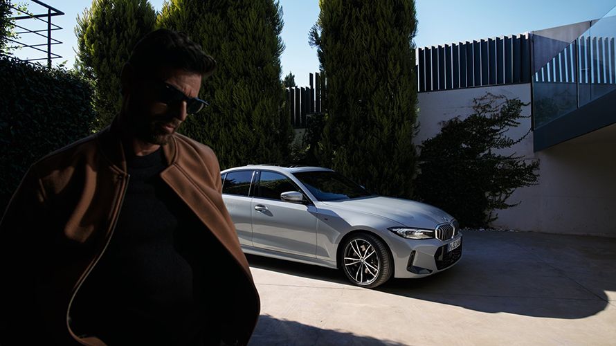 BMW Financial Services man walking away from  a BMW 