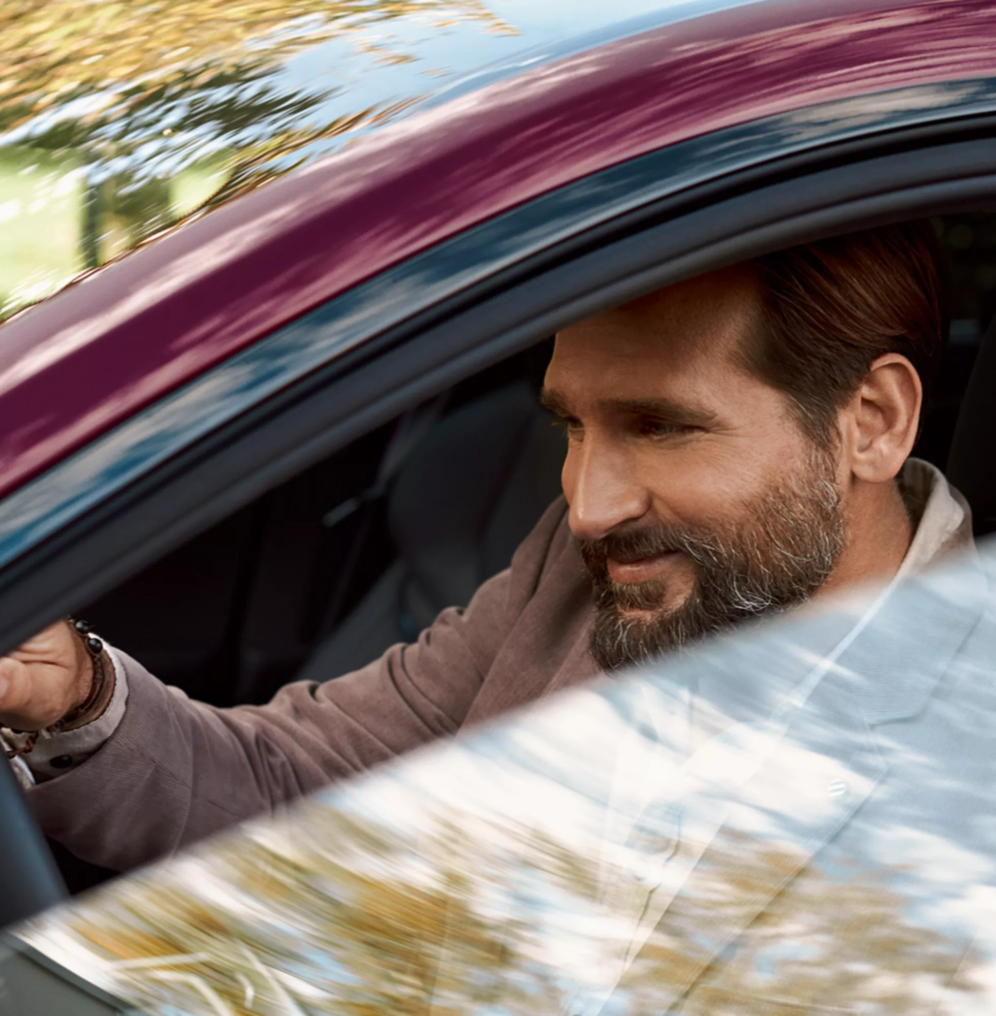 Person driving a red car outdoors