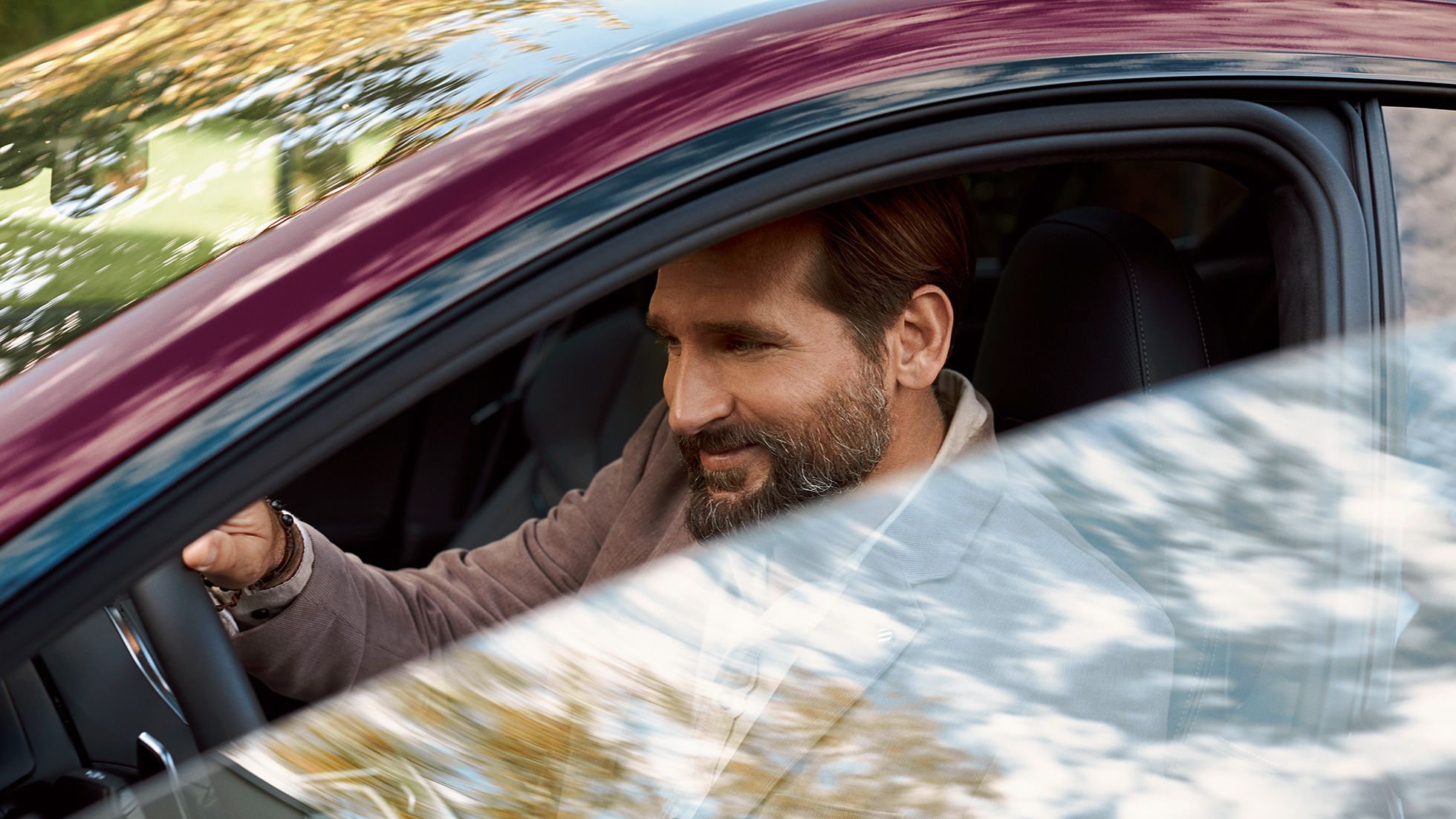 Person driving a red car outdoors