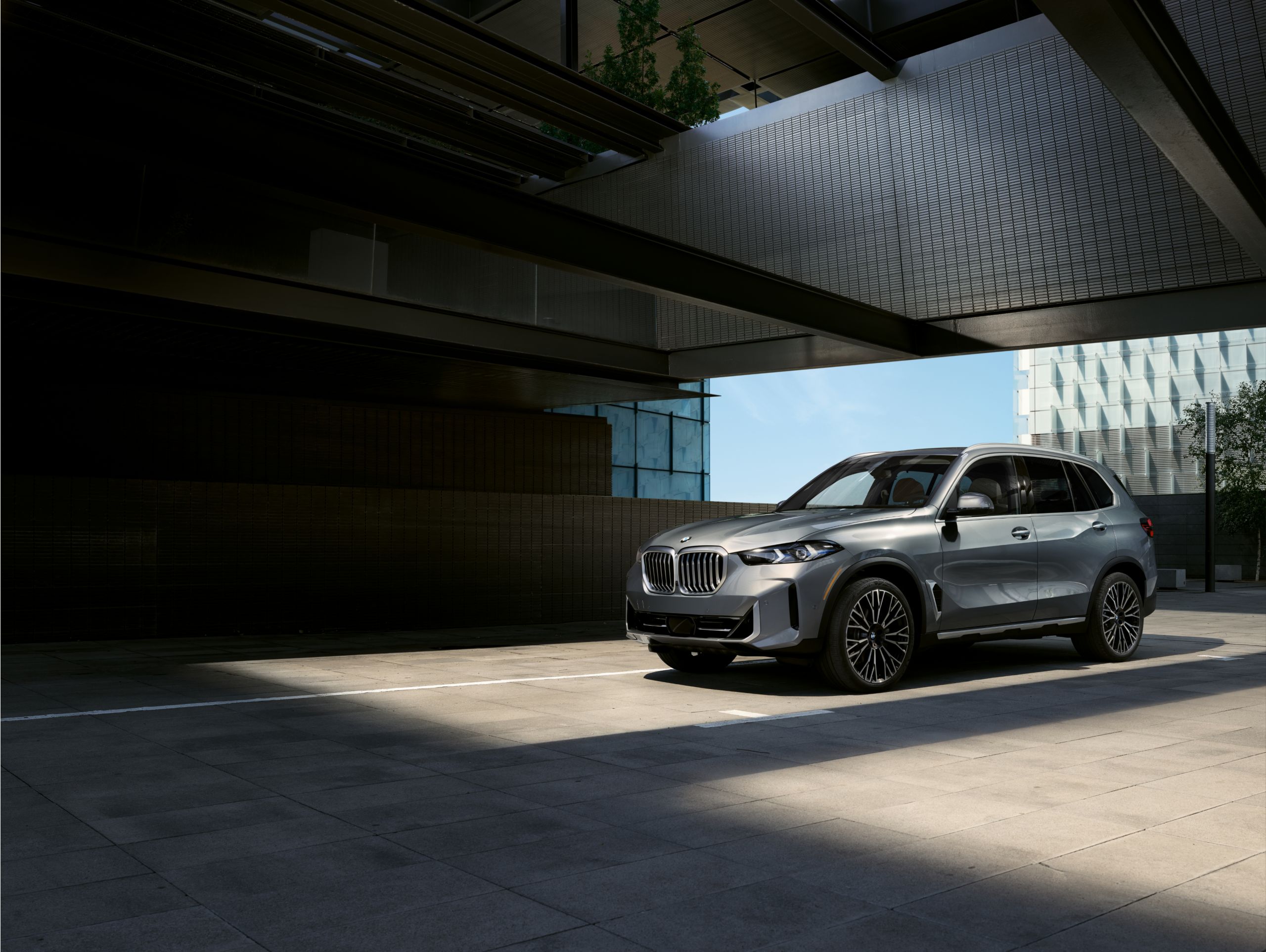 A BMW parked in a modern parking lot on a sunny day.