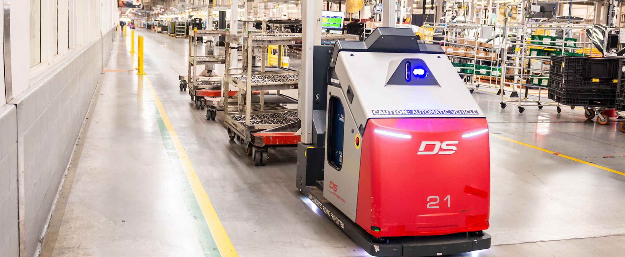 An interior shot of Plant Spartanburg where an automated machine moves several carts down the aisle of a production line.