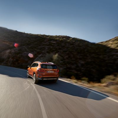 BMW X1 orange rear view 