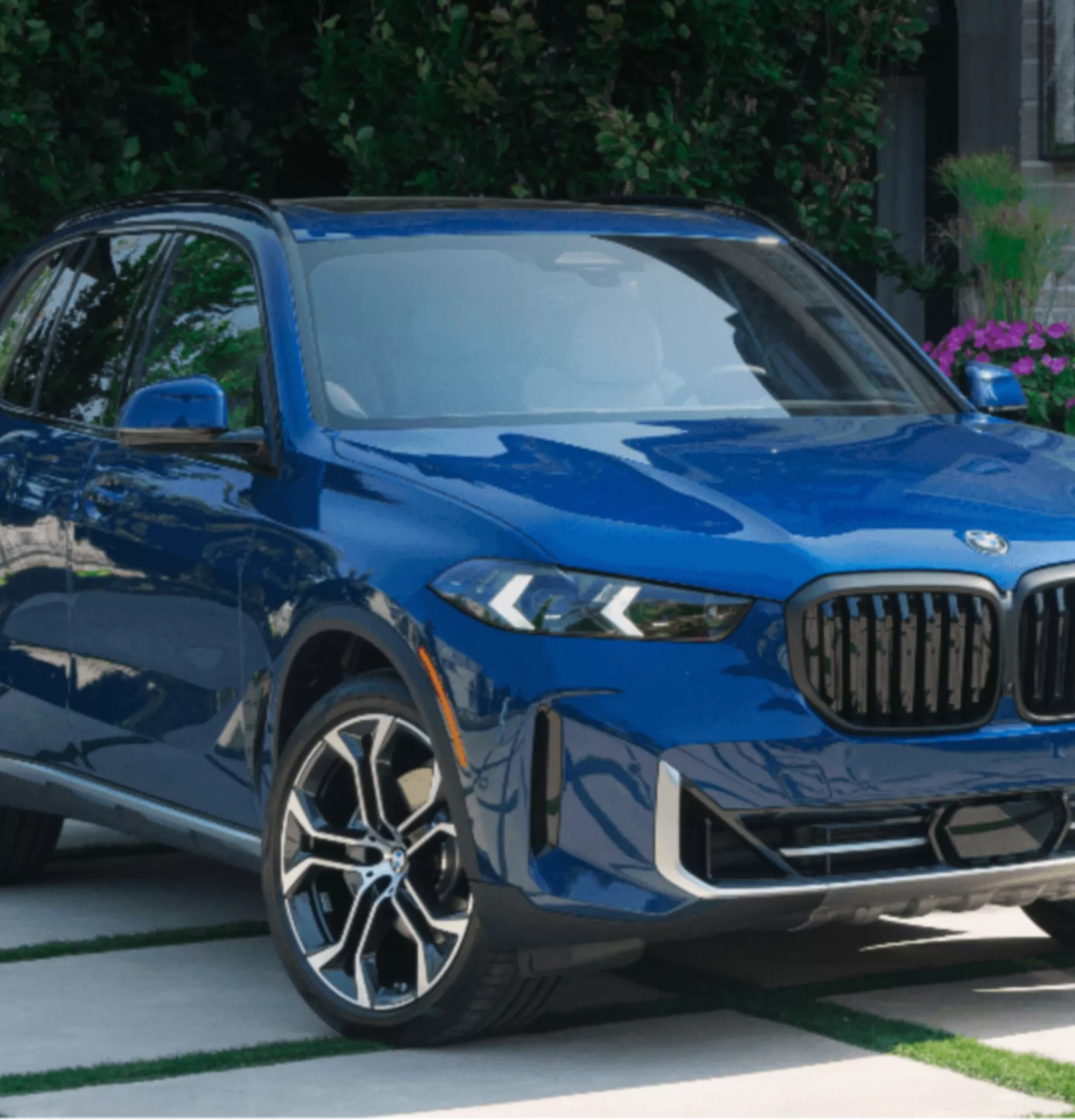 A person is operating the central display in the BMW iX3