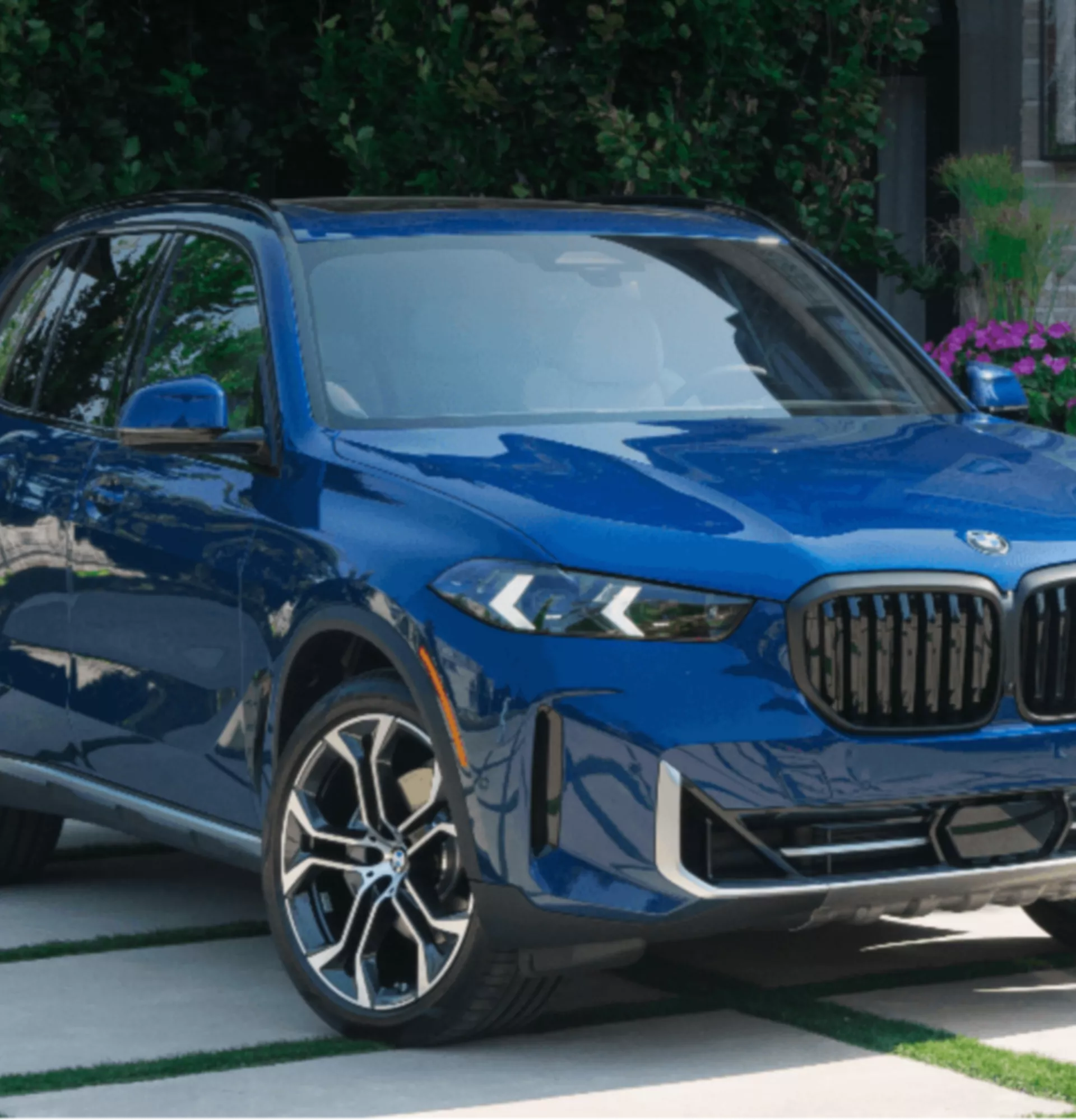 A person is operating the central display in the BMW iX3