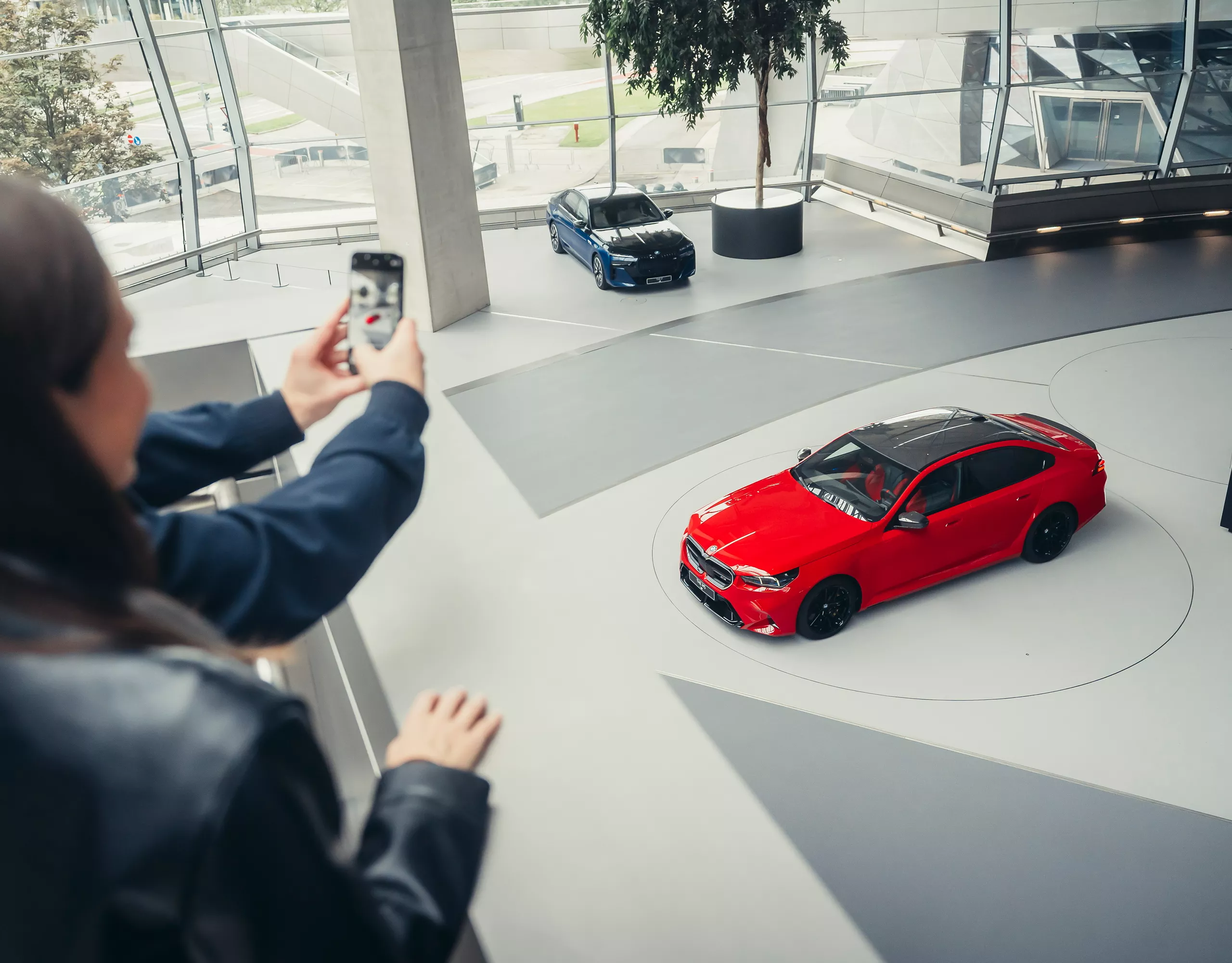 White BMW M5 with black bow on the pick-up platform of BMW Welt