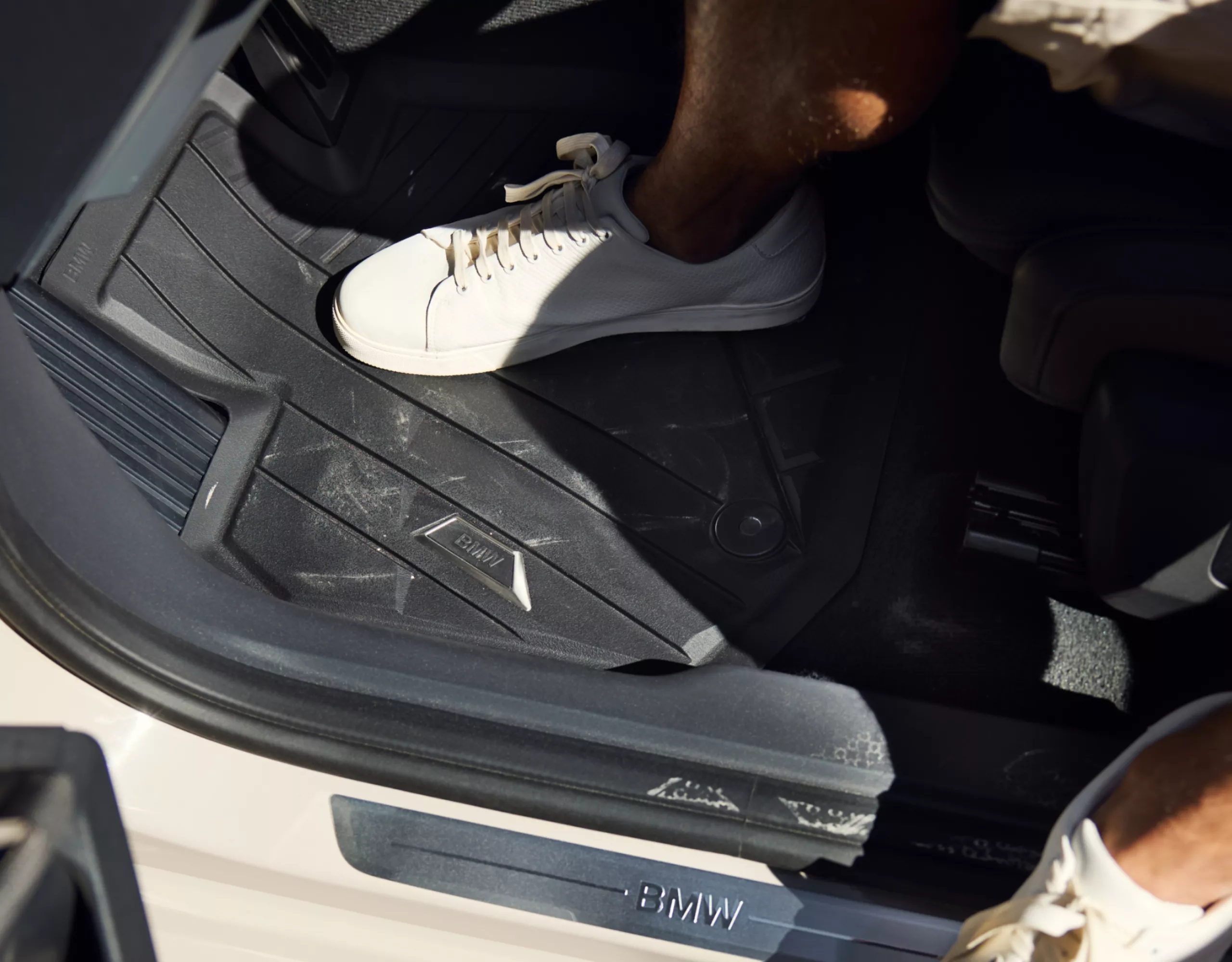 Person exiting BMW – detailed view of footwell