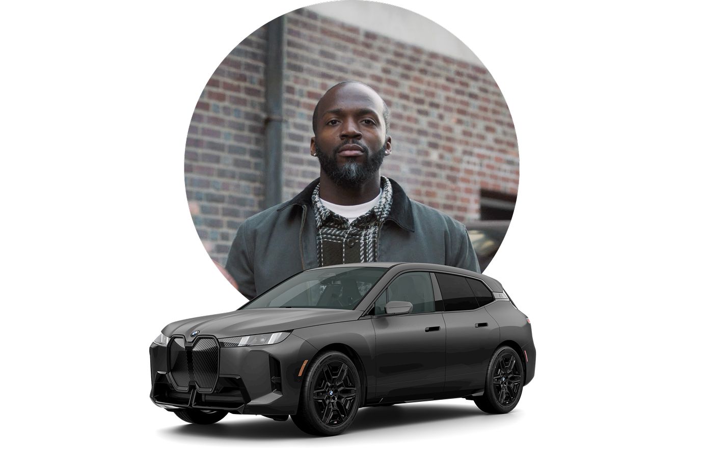 Justin poses for a photo in front of a brick wall with an icon of a BMW iX in front of him.