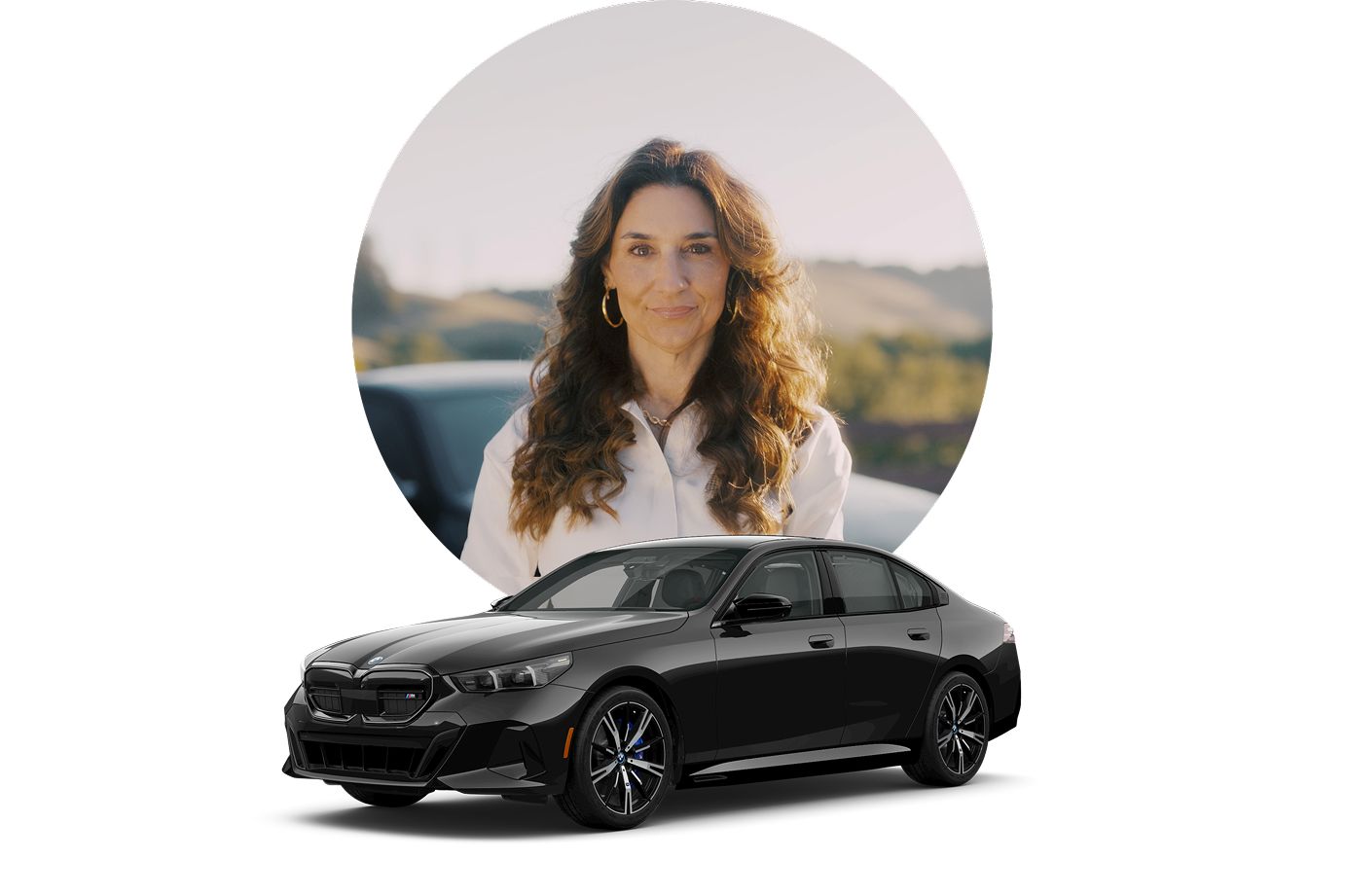 Renee poses for a photo in front of her parked BMW i5 with a camera in hand.